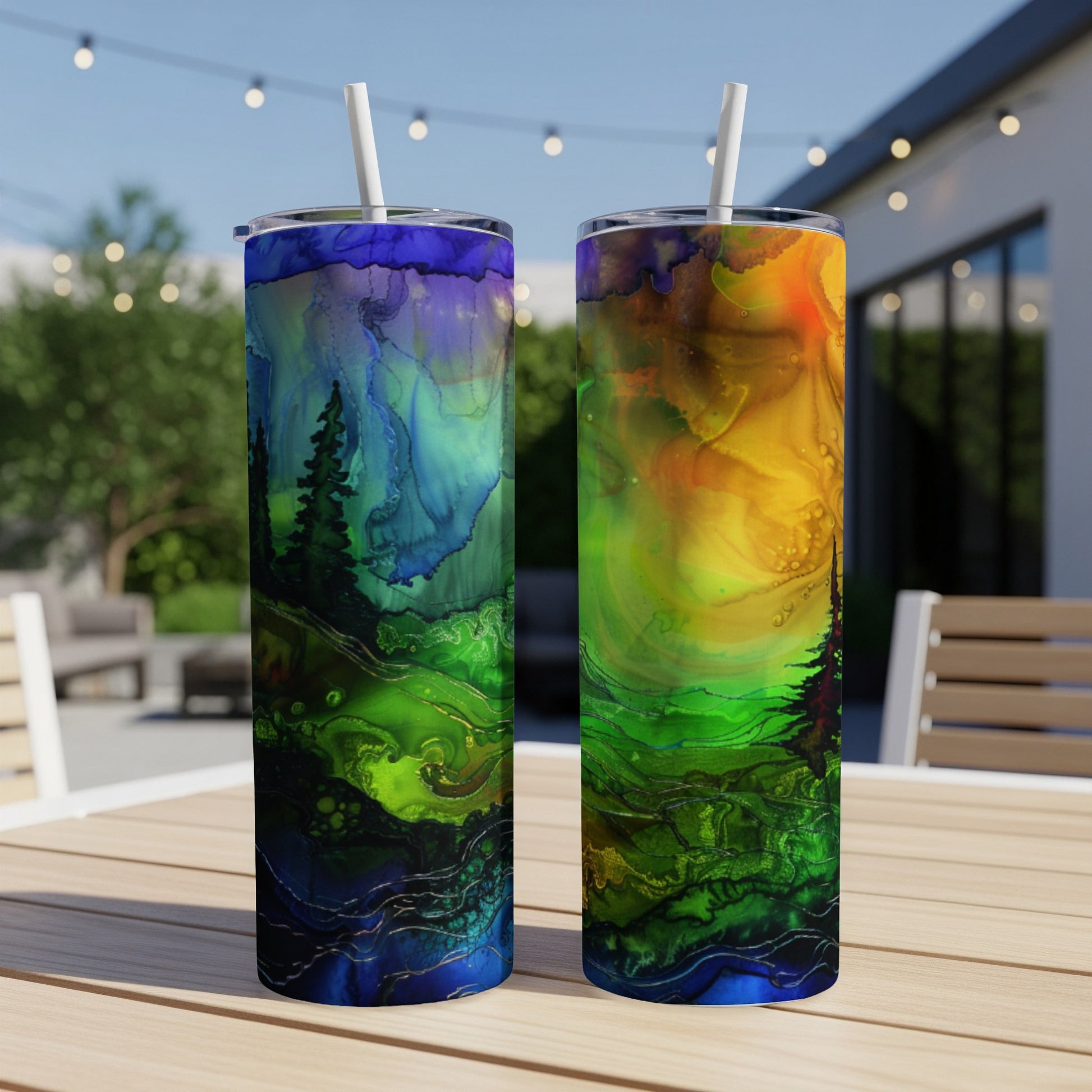 Two tall tumblers with vibrant, abstract forest night sky designs.