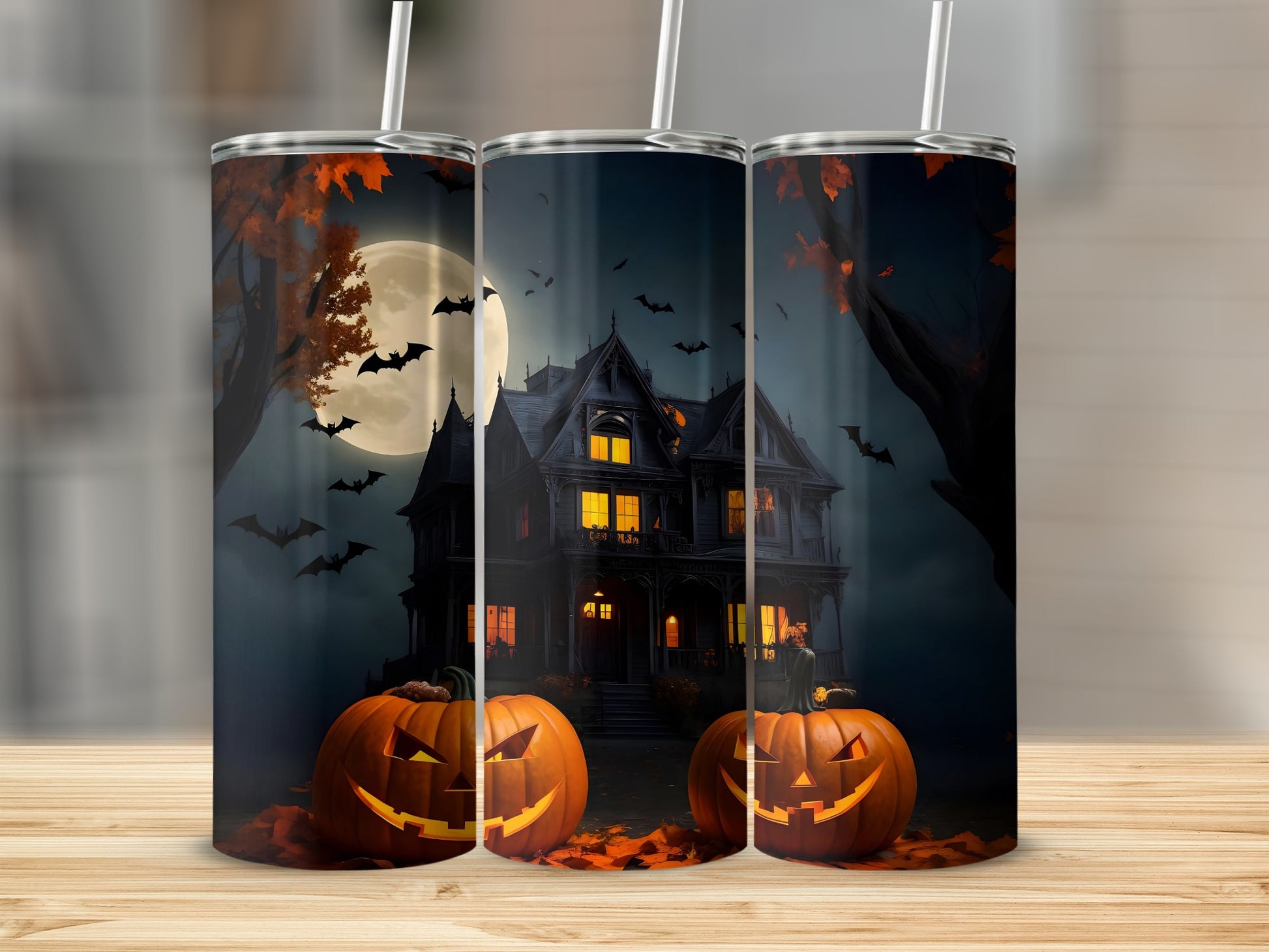 Halloween themed tumblers with haunted house, pumpkins, bats, and moon.