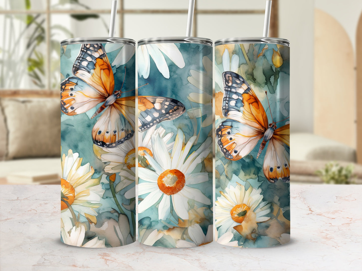 Triptych of tumblers with orange butterflies and white daisies on a blue watercolor background.