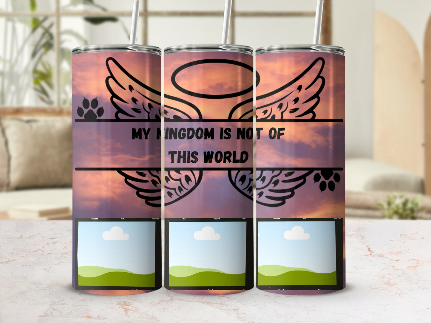 Three tumblers with a sunset sky, angel wings, paw prints, and text.