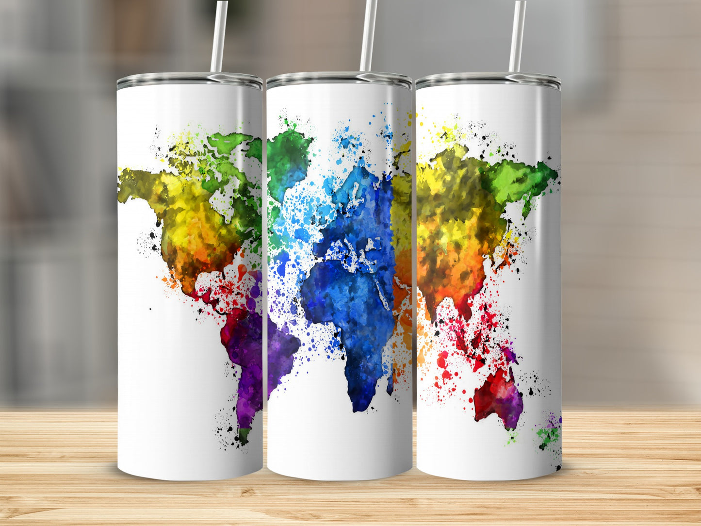 Three white tumblers featuring a colorful watercolor world map design.