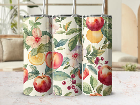 Floral and fruit pattern on three tumblers with straws, set on a countertop.
