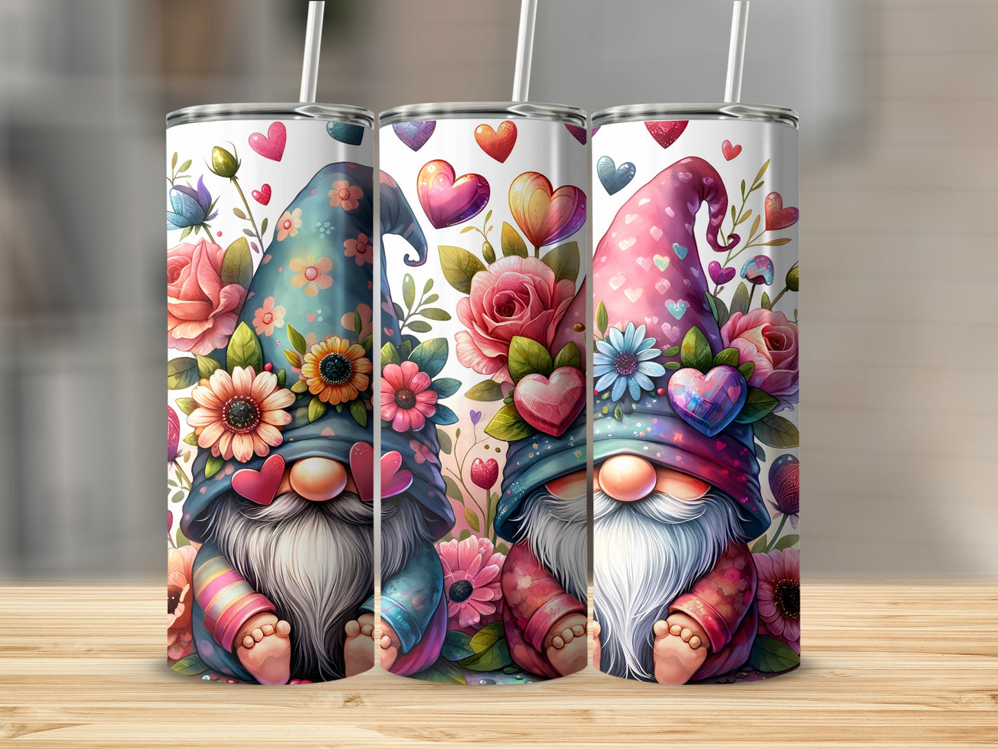 Two gnomes with floral hats and hearts on a tumbler, against a wooden surface.