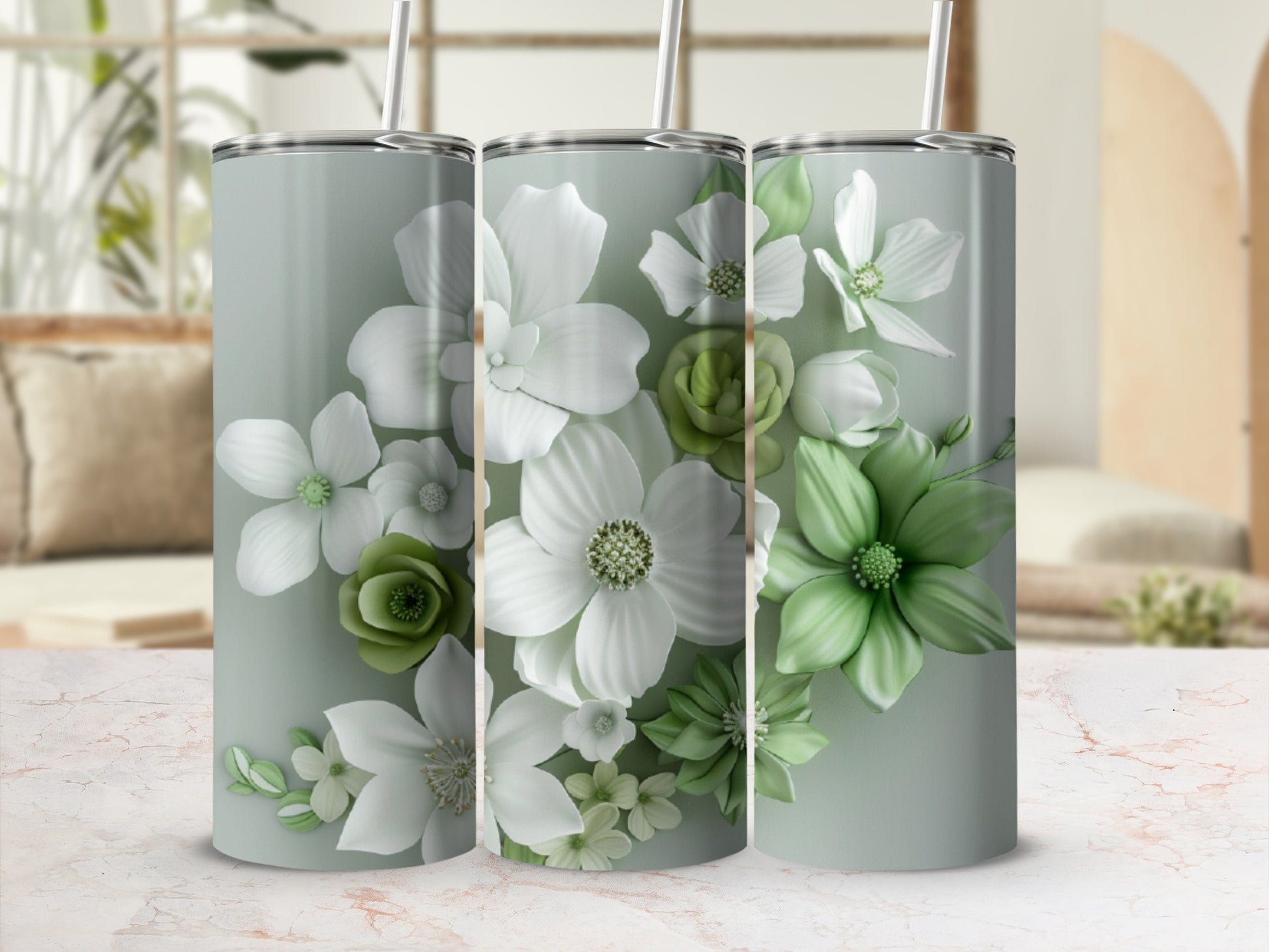 Three tumblers with a pale green background and a floral design of white and green flowers.
