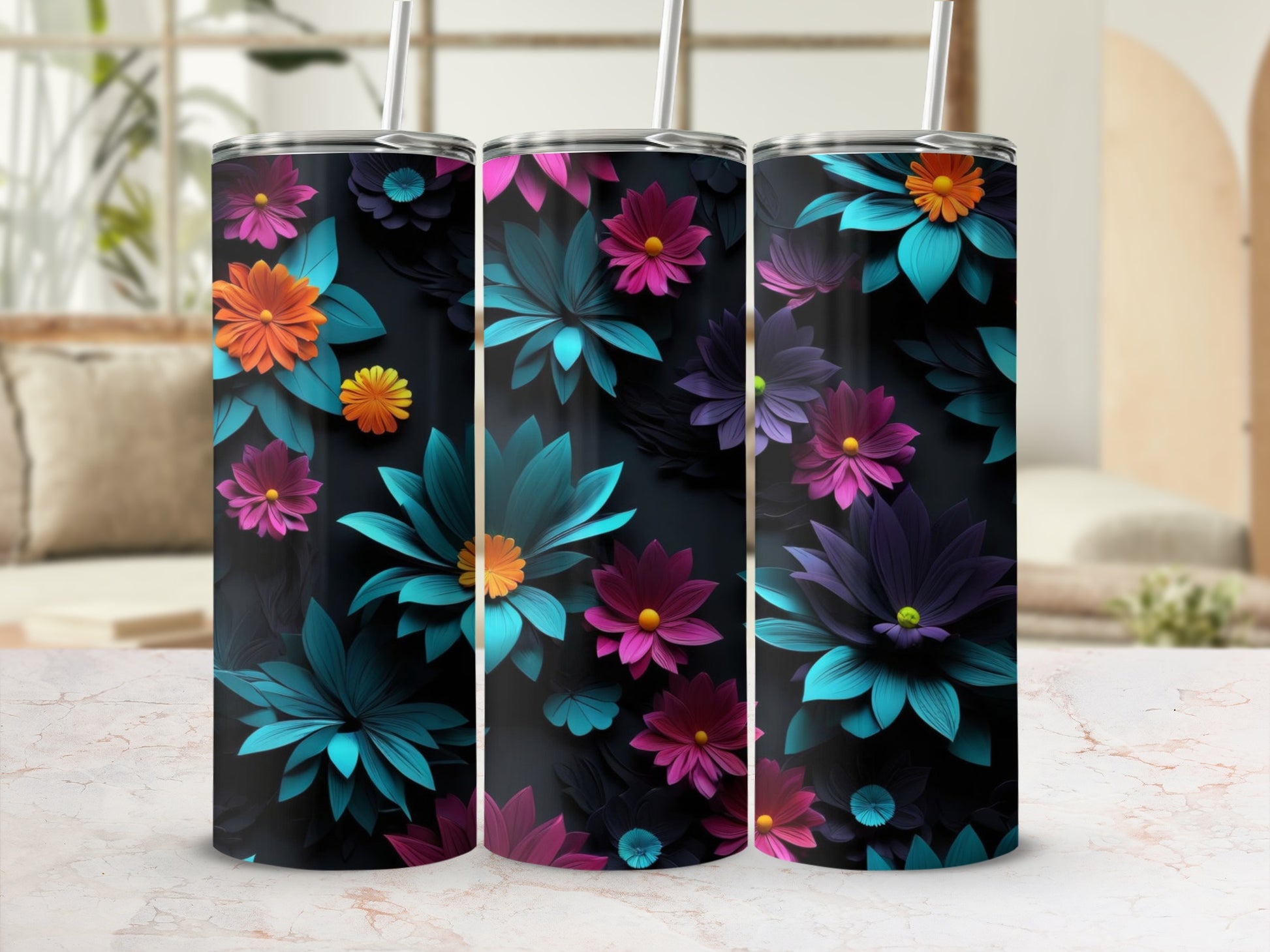 Three tumblers with vibrant floral designs on a marbled surface.