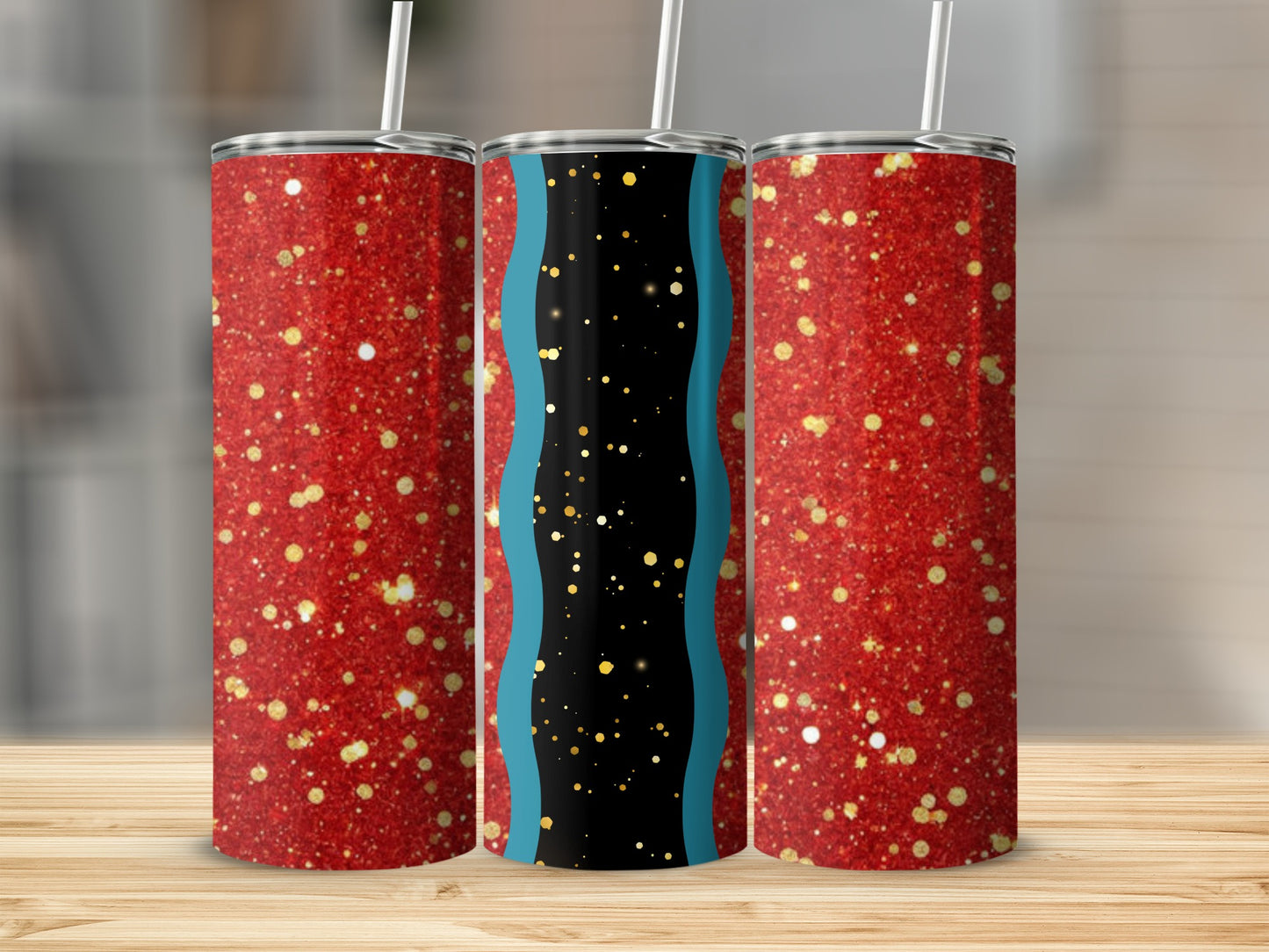 Three glitter tumblers with red, gold, and black patterns on a wooden surface.