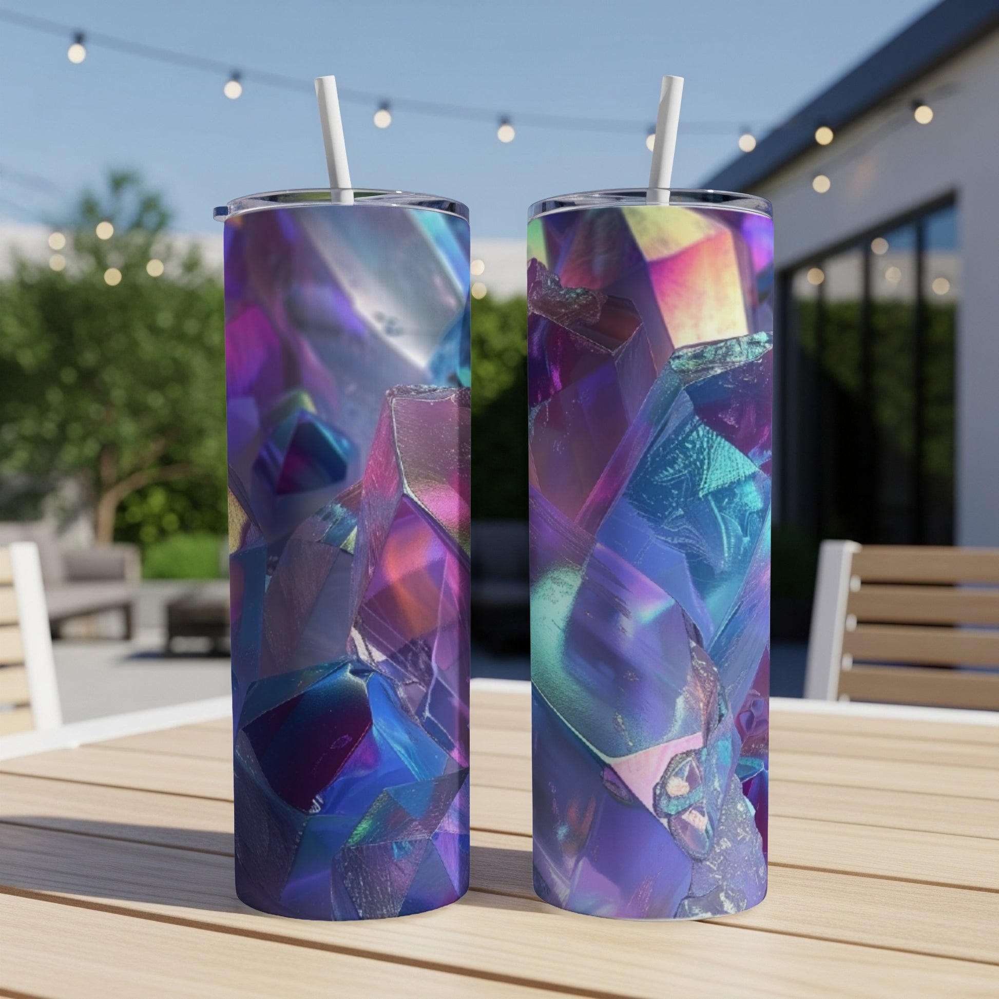 Two tumblers with iridescent gemstone designs on a wooden table.