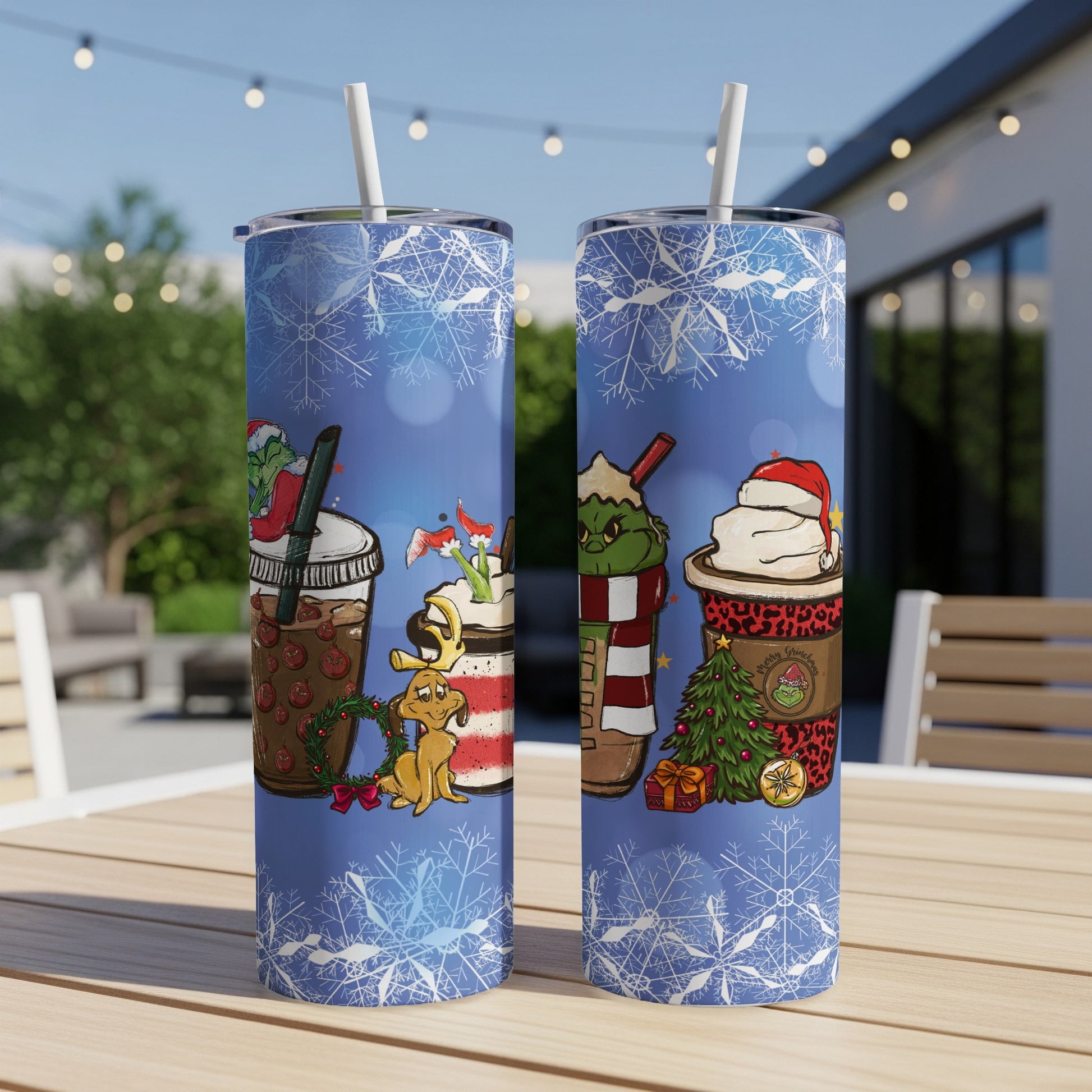 Two Grinch-themed tumblers with Christmas and coffee designs on a table.