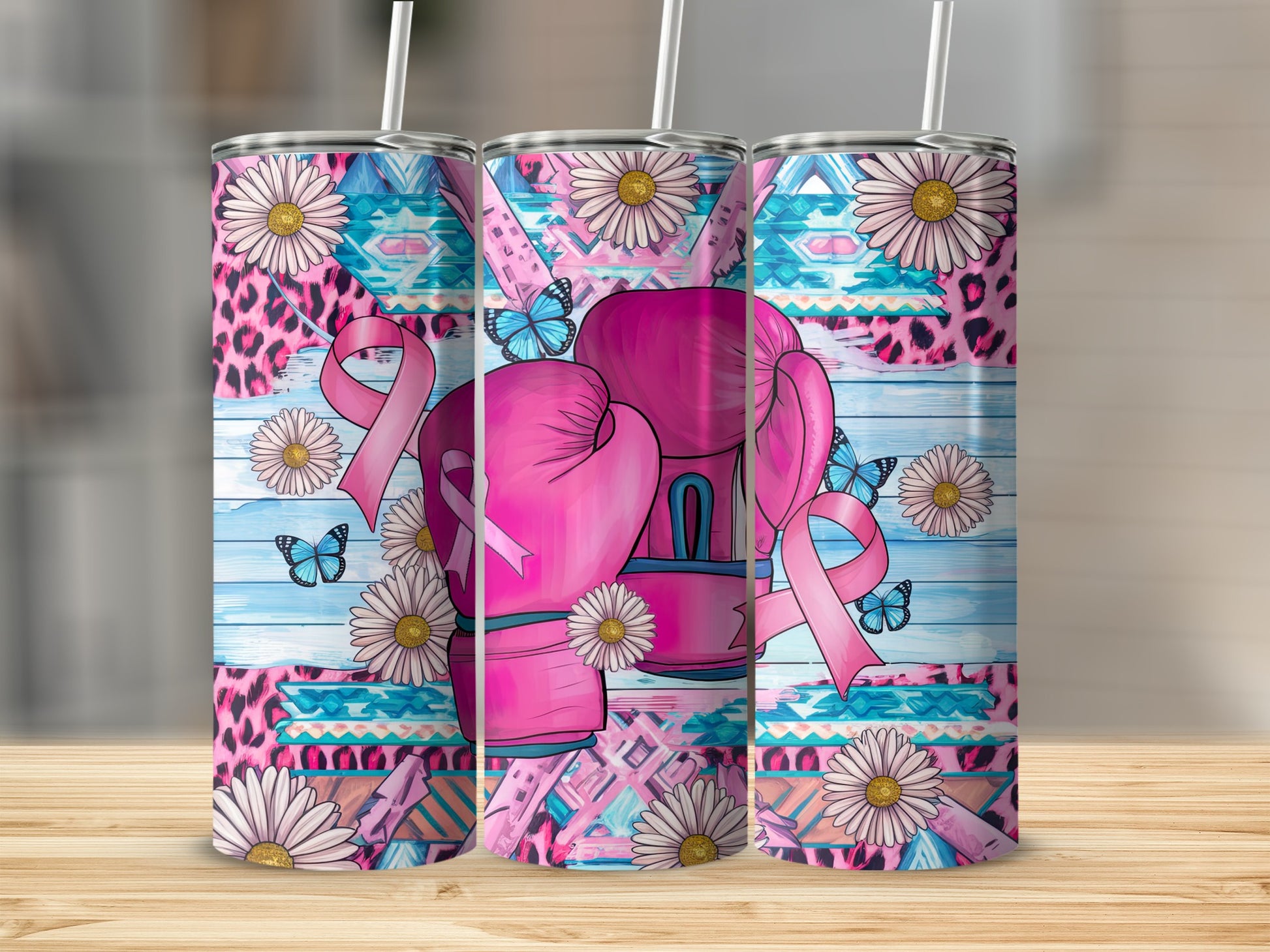Pink boxing gloves and flowers with butterflies on a colorful patterned tumbler.