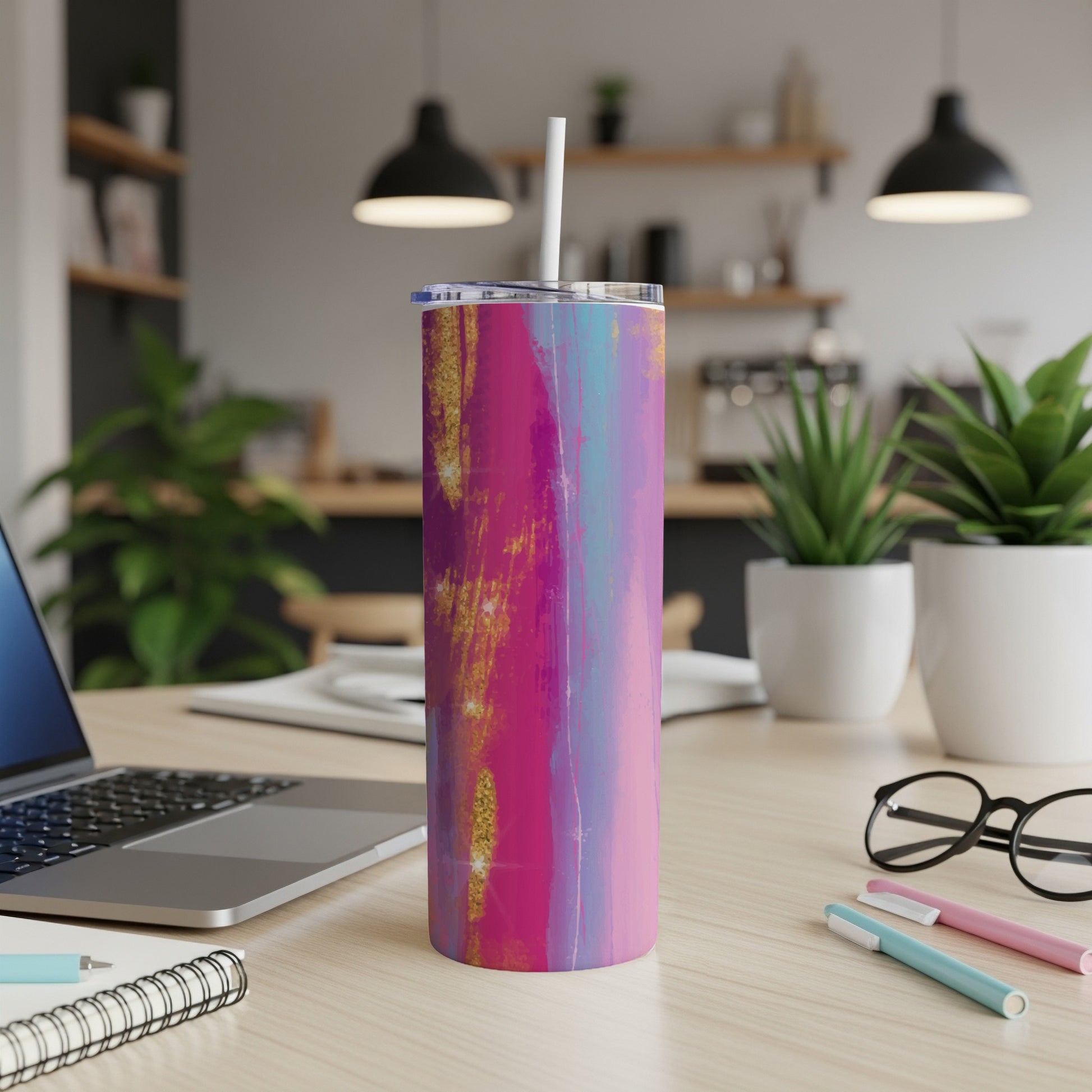Tumbler with abstract pink, blue, and gold brushstroke design and white straw.