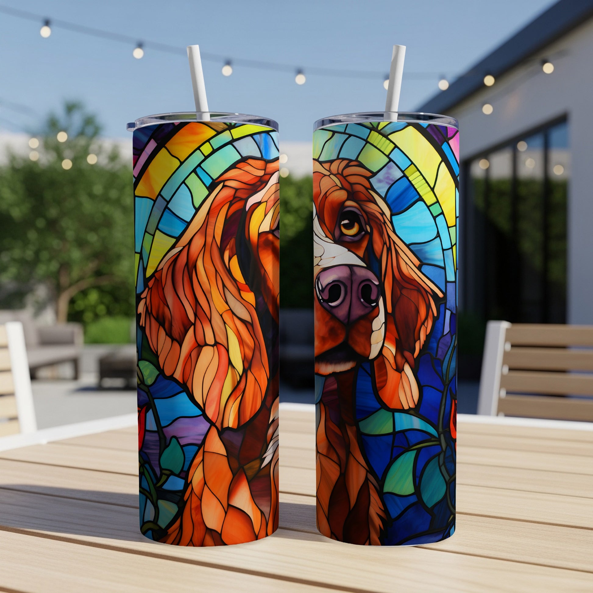 Stained glass dog portrait on two tumblers on an outdoor table.