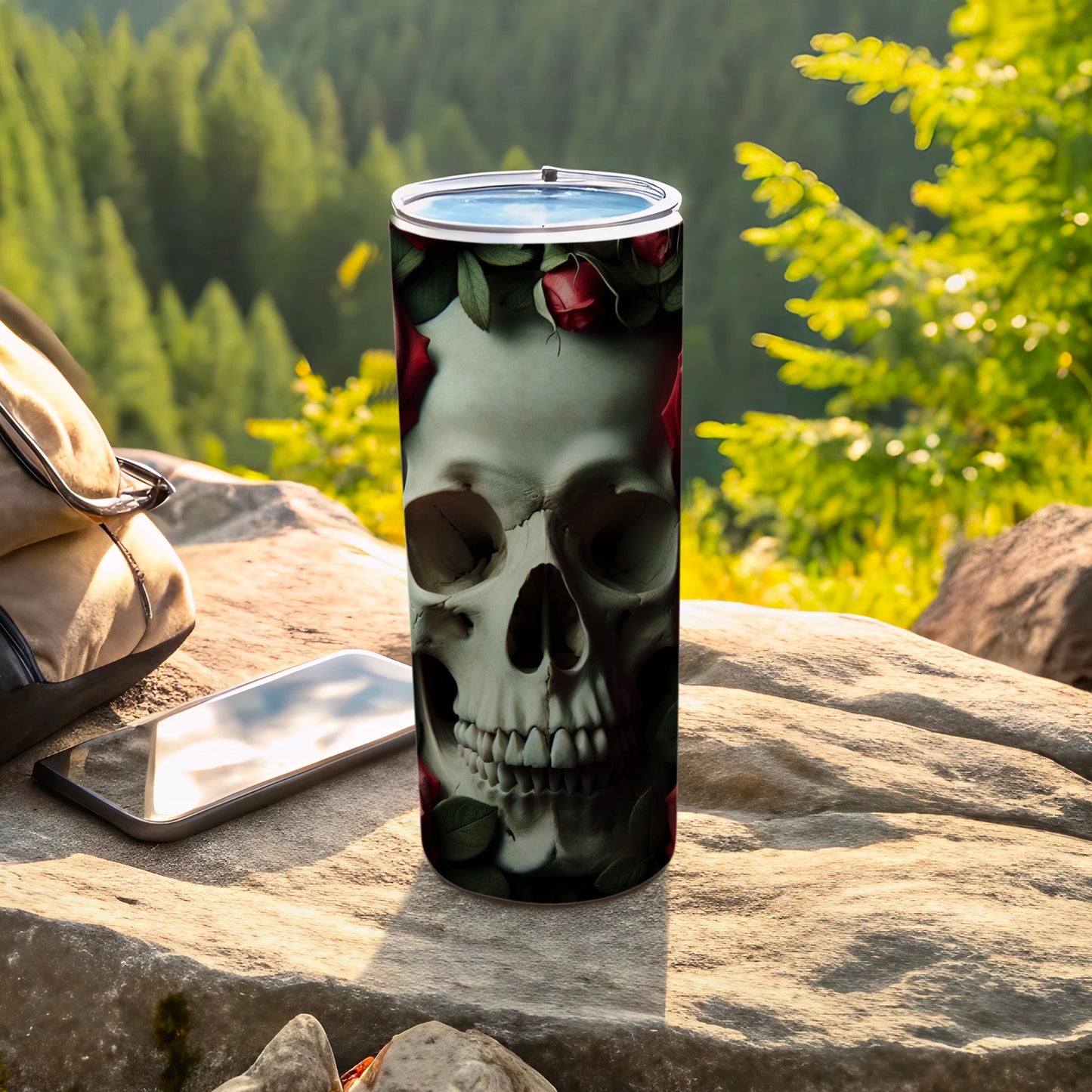 Tumbler featuring a skull and roses design with a natural outdoor background.