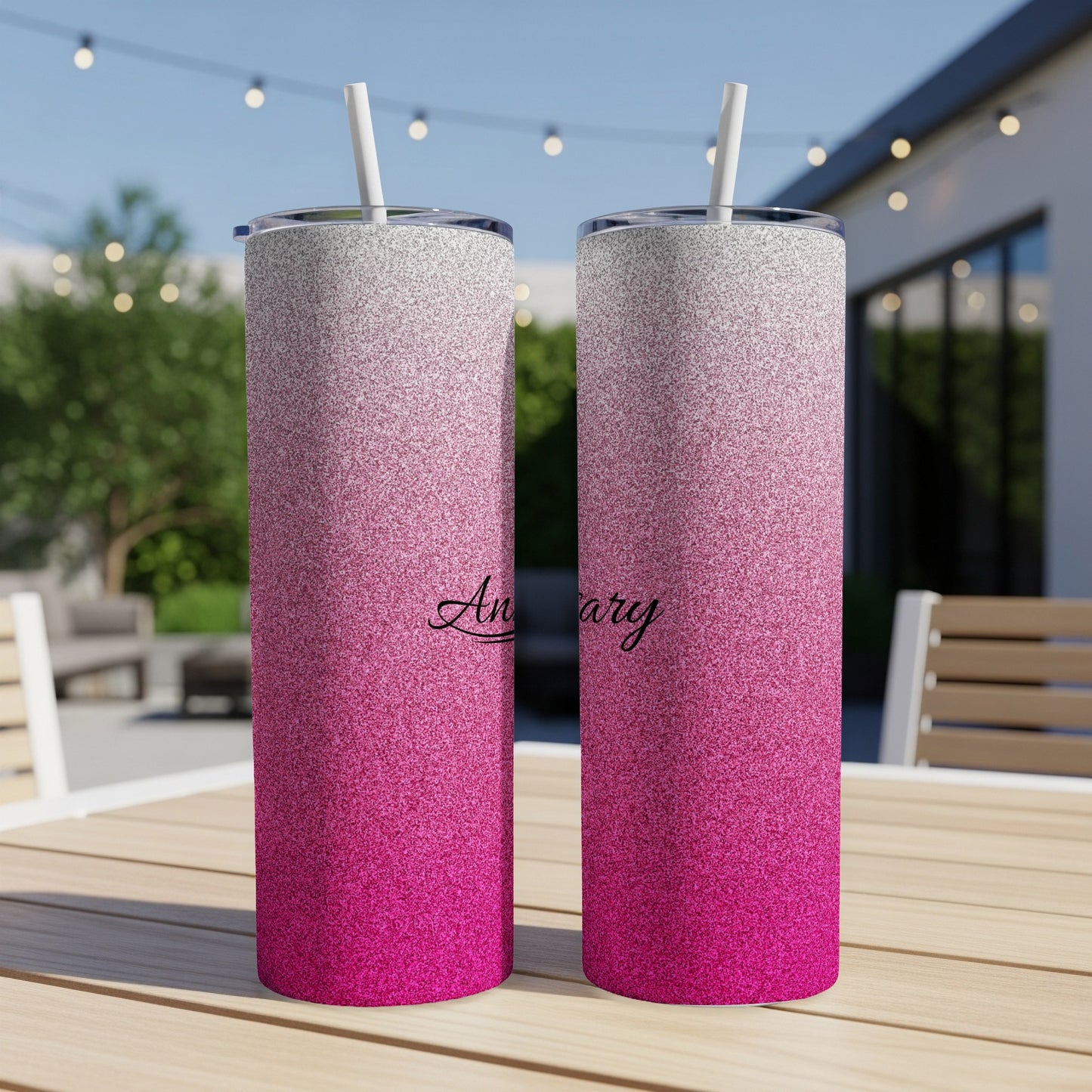 Two pink glitter tumblers with "Anniversary" text on a table.