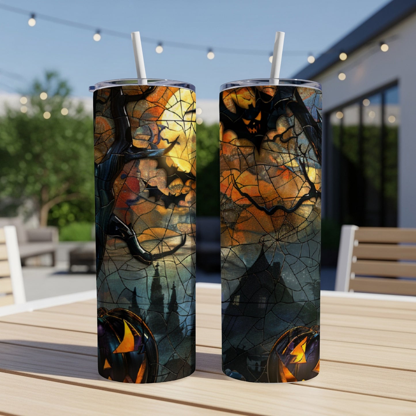 Two Halloween tumblers with spooky castle and pumpkin design.