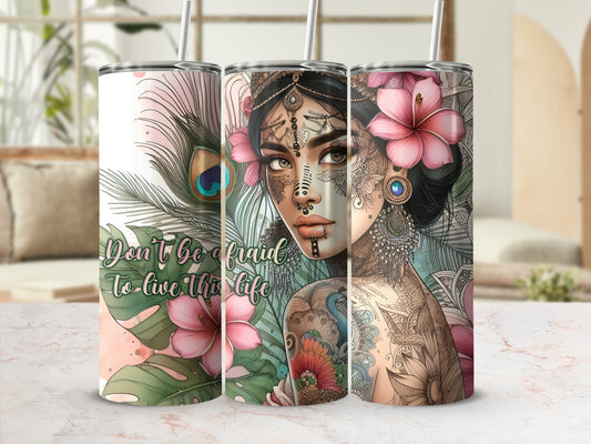 Bohemian woman with tattoos and flowers on tumbler with inspirational quote.