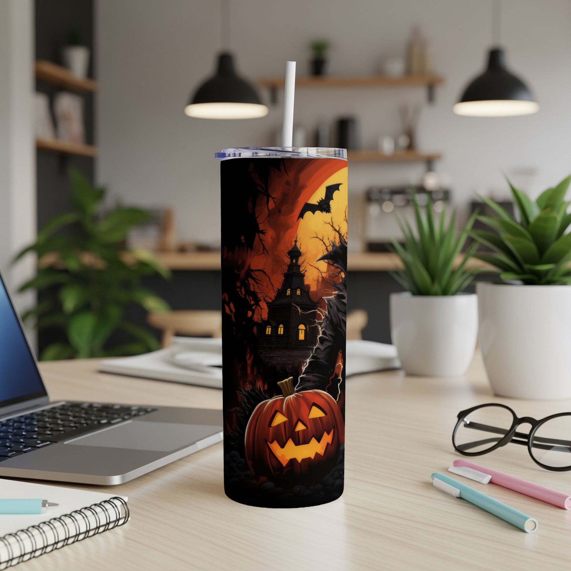 Halloween tumbler with a haunted house, pumpkin, and bat design.