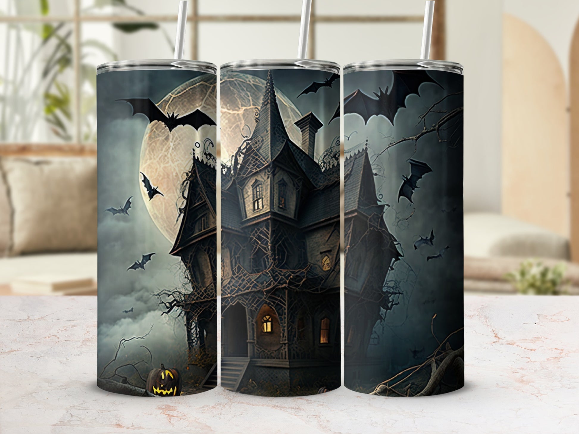 Haunted house with bats and full moon design on three tumblers.