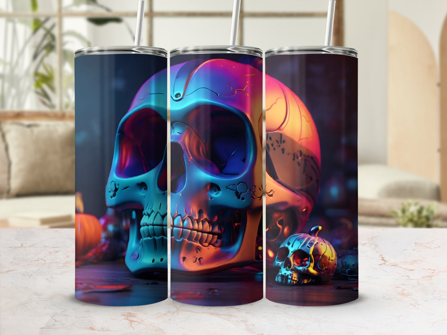Three colorful, metallic skull tumblers on a patterned surface with pumpkins.