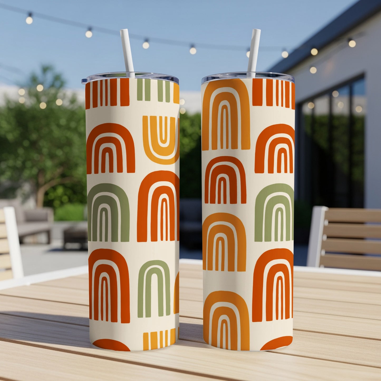 Two tumblers with mid-century modern rainbow and stripe patterns.