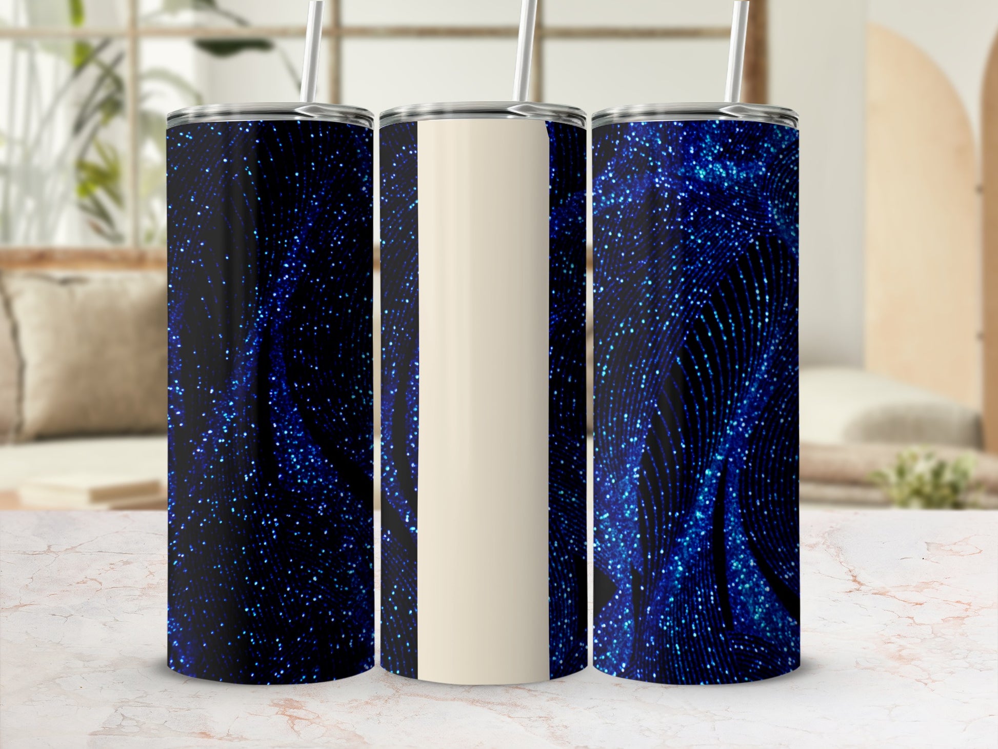 Three tumblers with a swirling blue glitter design on a light marble surface.