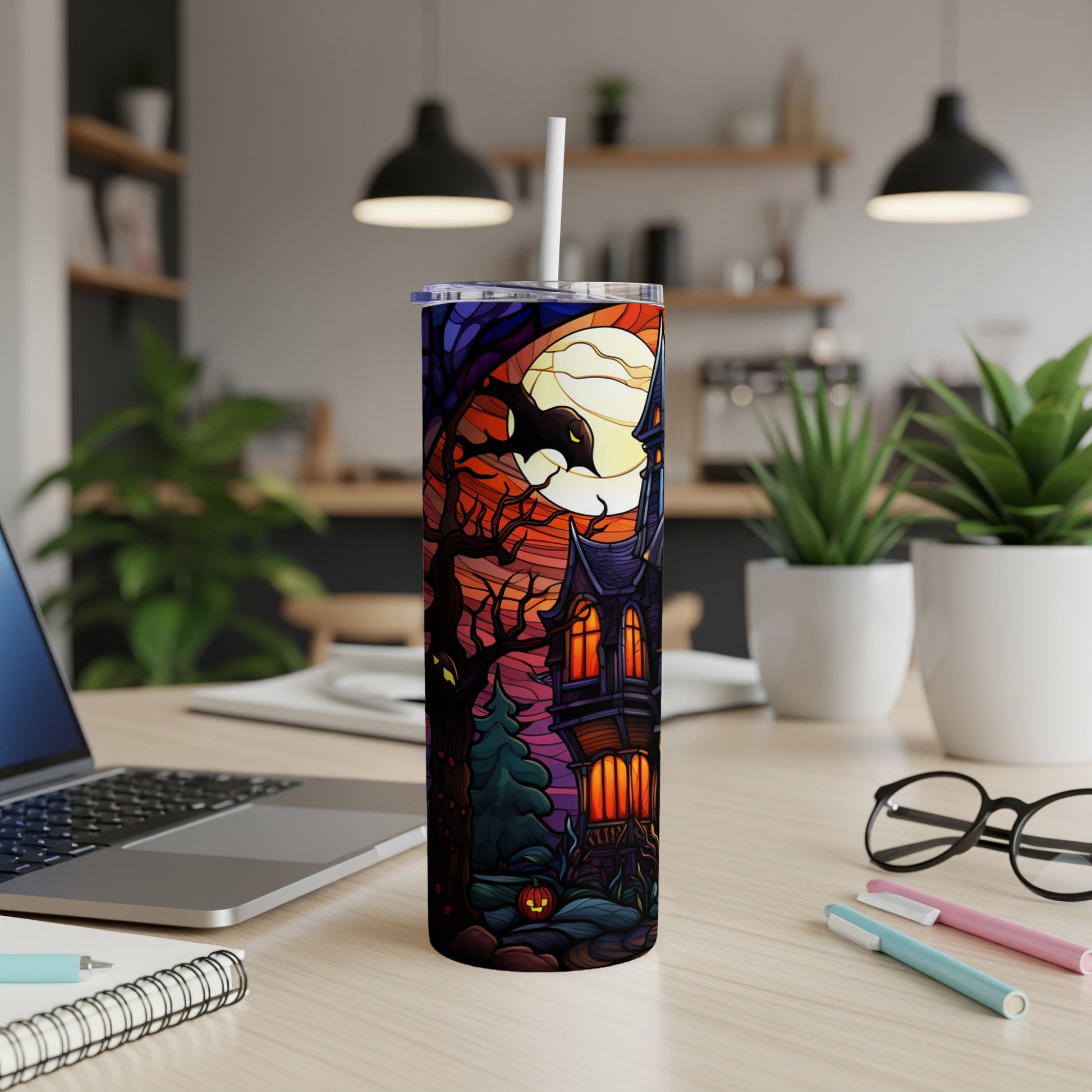 Spooky haunted house and moon illustration on a Halloween tumbler.