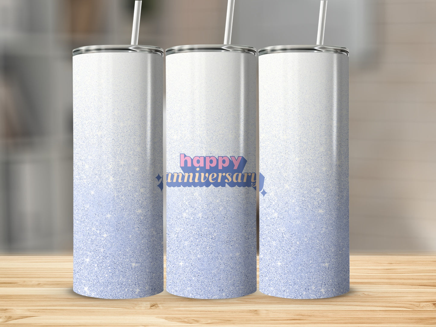 Three skinny tumblers with a "happy anniversary" design and glitter accents.