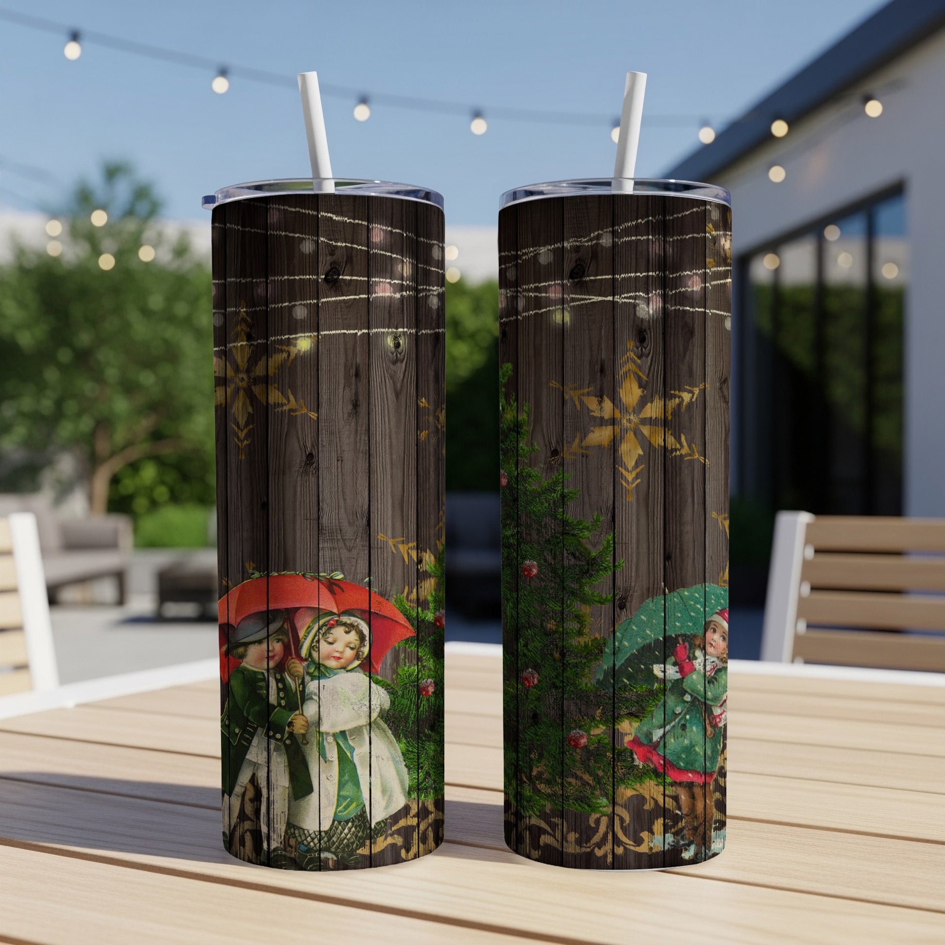 Two tall tumblers with vintage Christmas children and snowflakes on wood background.