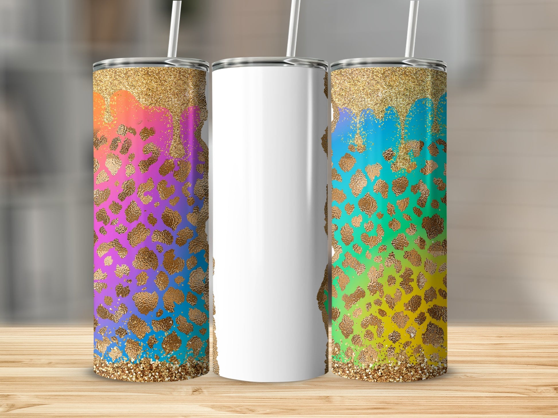 Three tall tumblers with glitter and leopard print designs on a wooden surface.