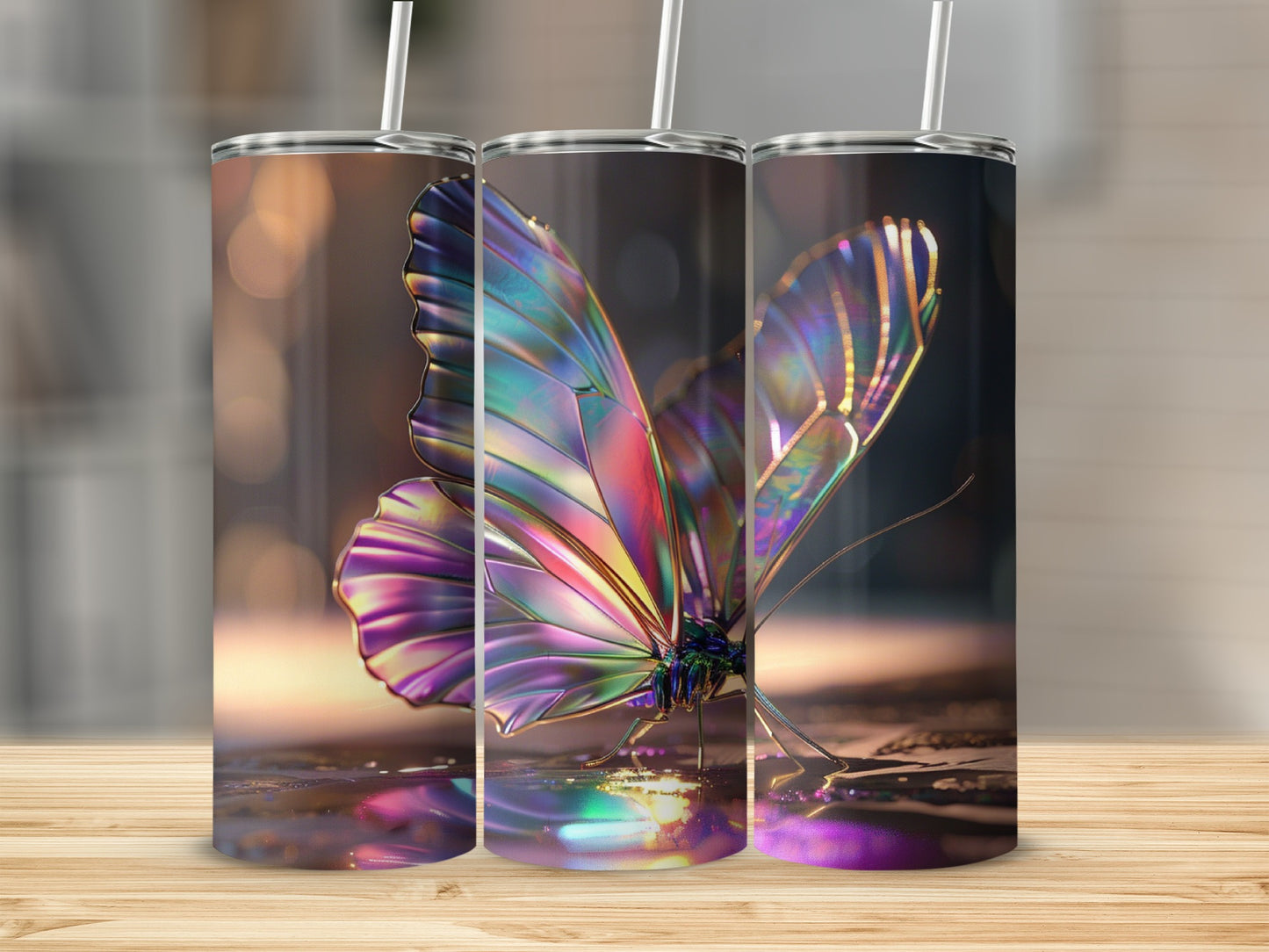 Three tumblers with iridescent butterfly designs and straws.