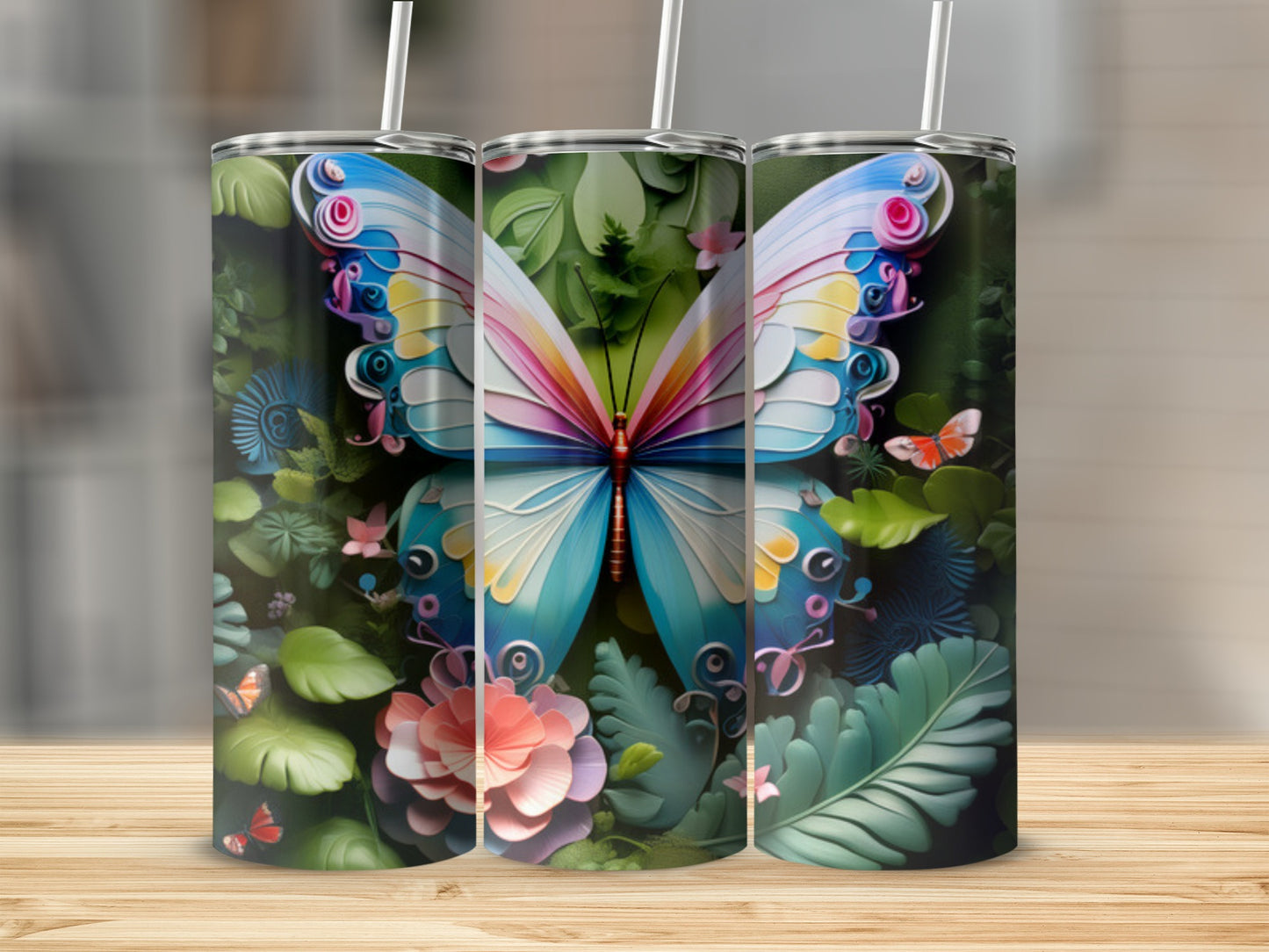 Three tumblers with vibrant butterfly and floral designs.