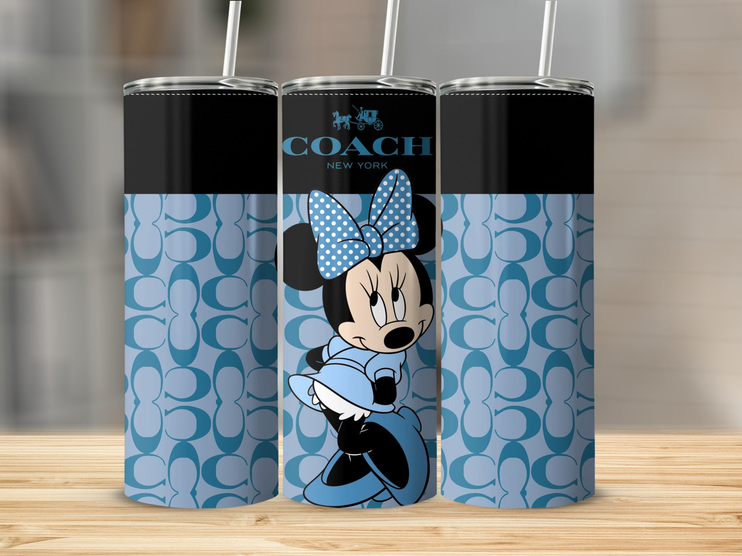 Coach New York tumblers featuring Minnie Mouse in a light blue dress and polka dot bow.