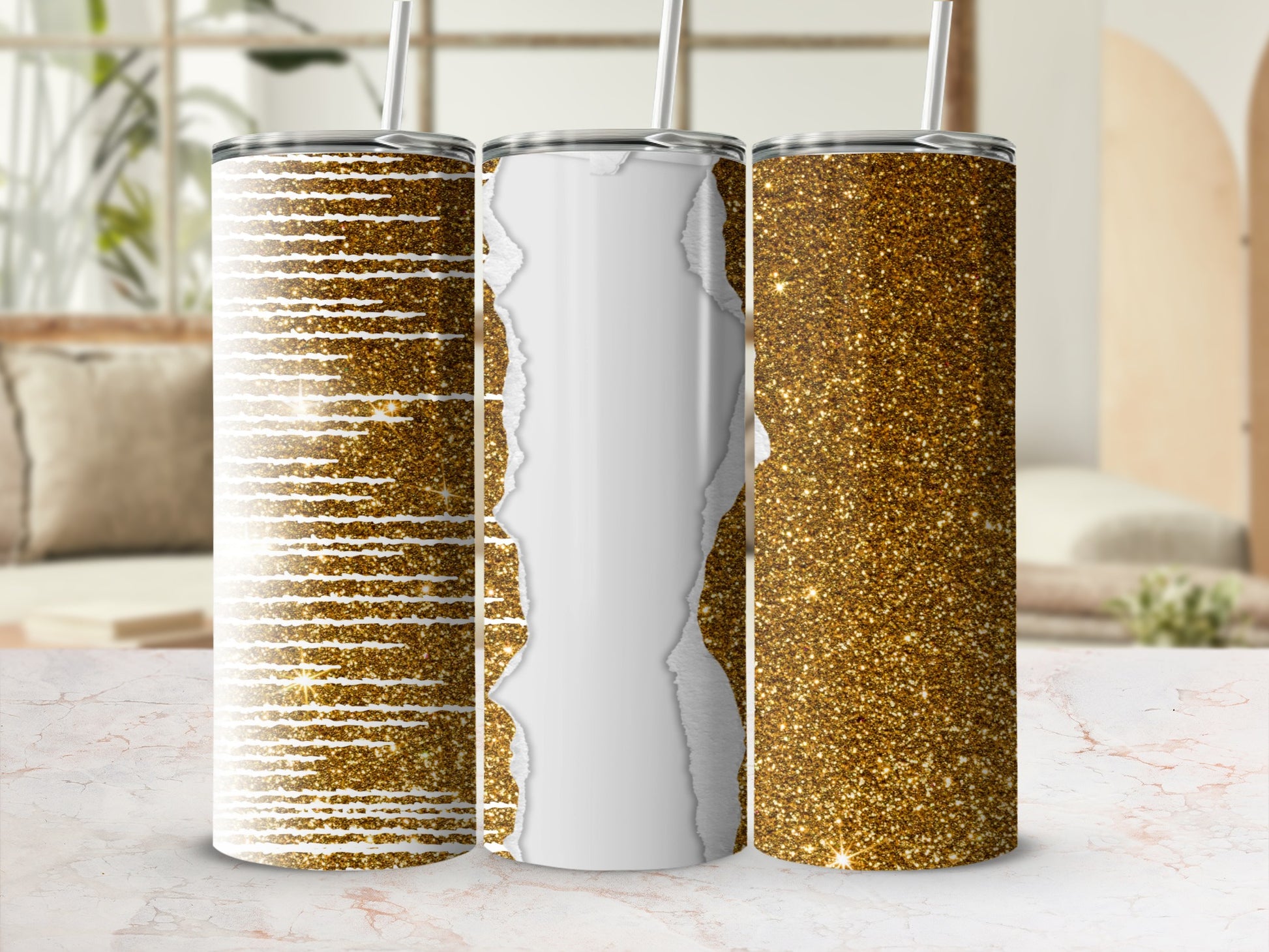 Three glitter tumblers, one with a torn paper effect, on a marbled surface.