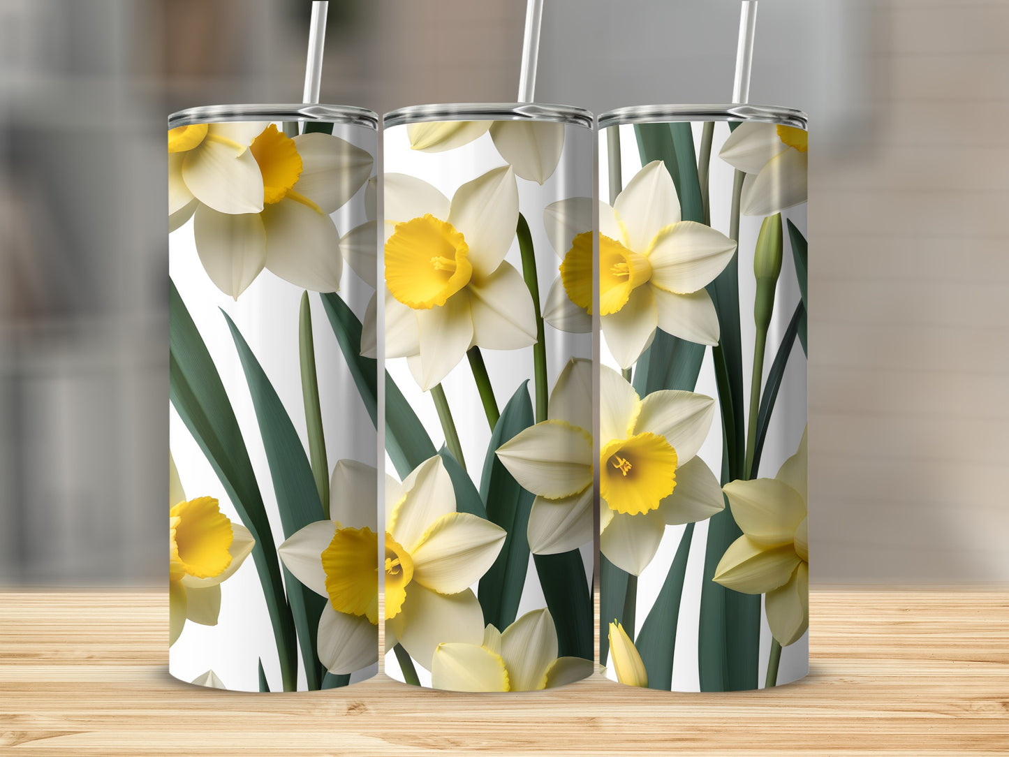 Three white and yellow daffodils on tumblers with green leaves.