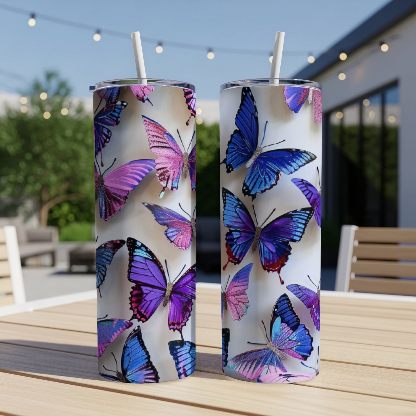 Two tumblers with iridescent purple and blue butterfly designs on a table.