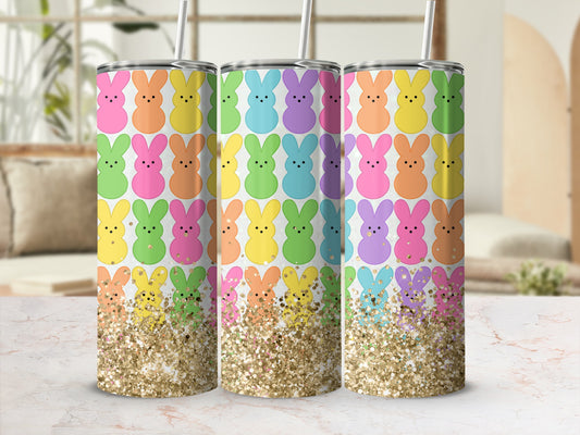 Three tumblers with colorful bunny patterns and glitter bases.