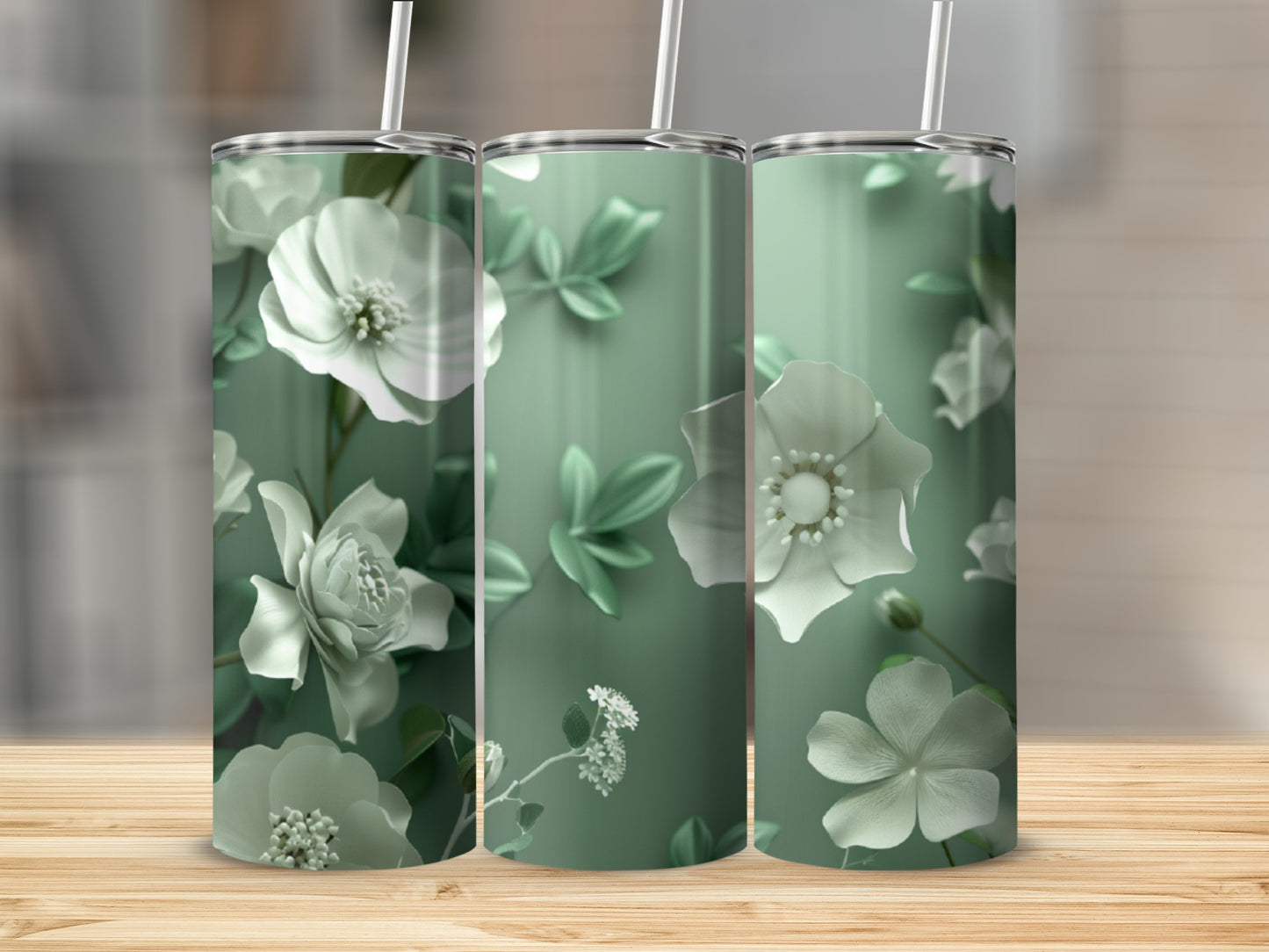 Three tumblers with white floral designs on a muted green background.