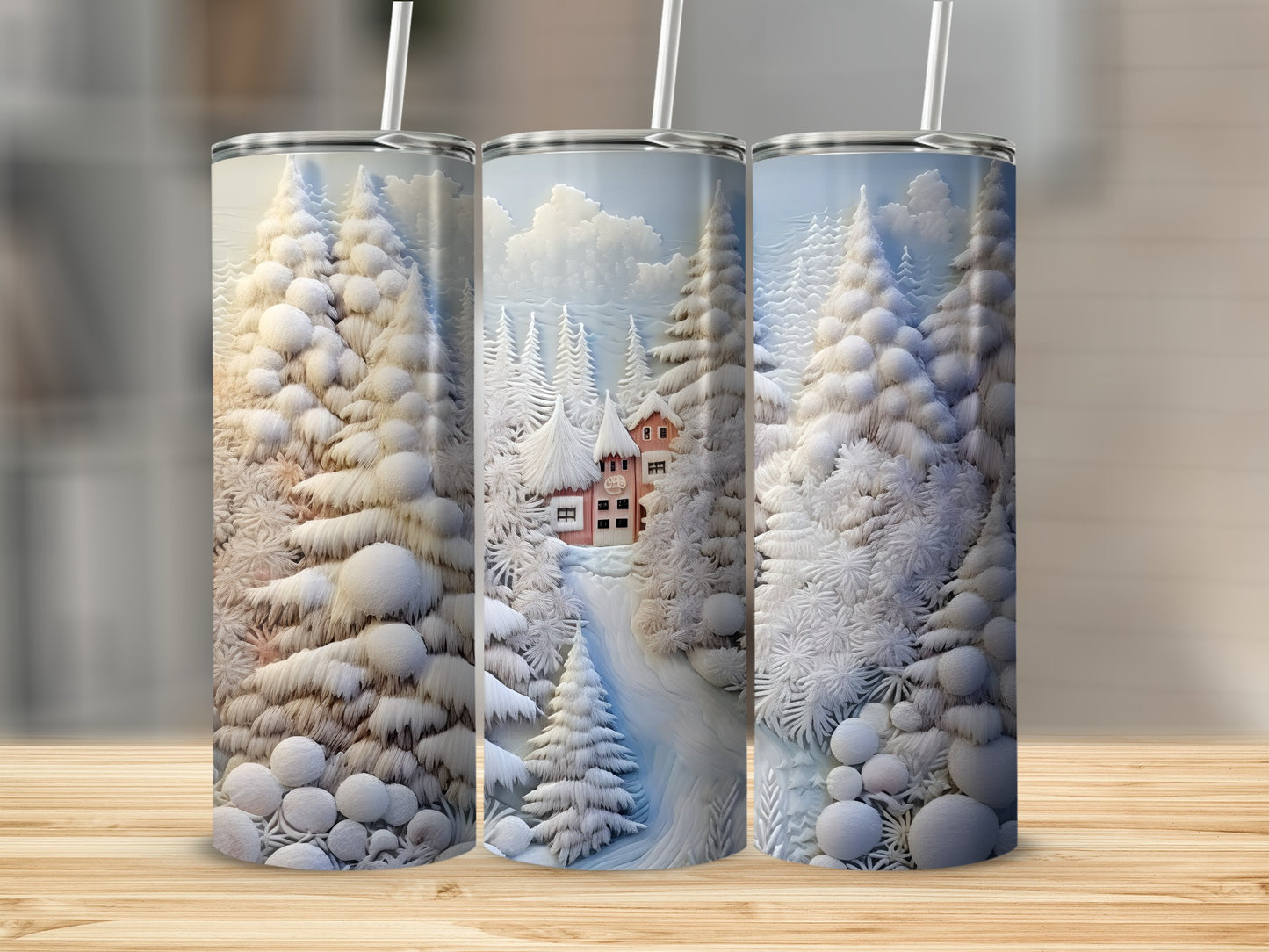 Three snow-covered tumblers feature a winter village scene with trees and a red house.