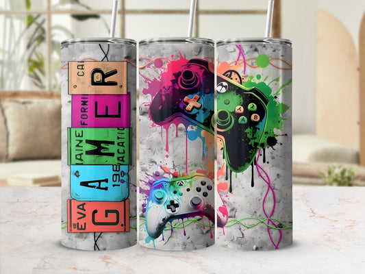 Three tumblers with a gaming controller design and colorful paint splatters.