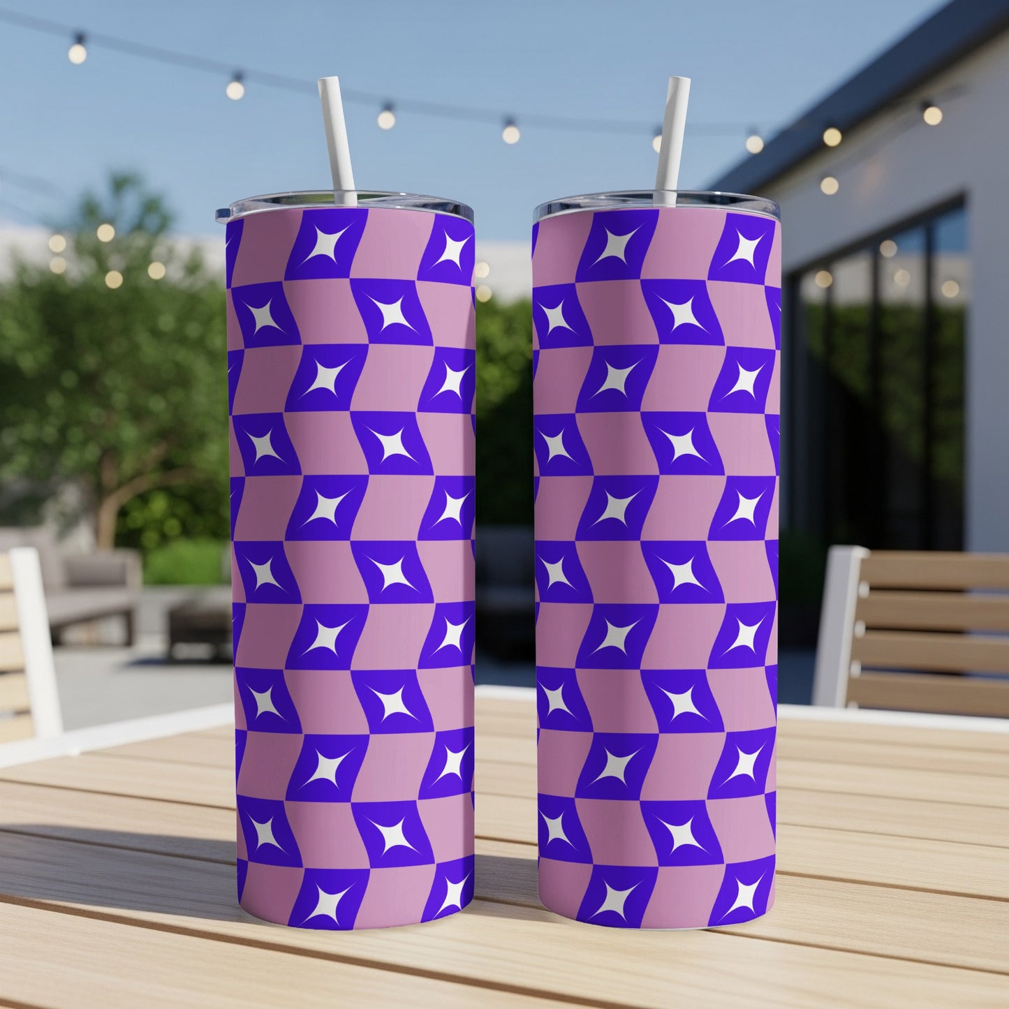 Two purple tumblers with a geometric white and purple pattern and straws.