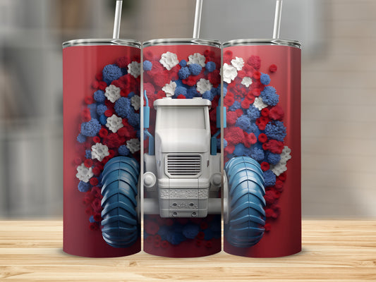 White tractor with blue wheels surrounded by red, white, and blue flowers on a tumbler.