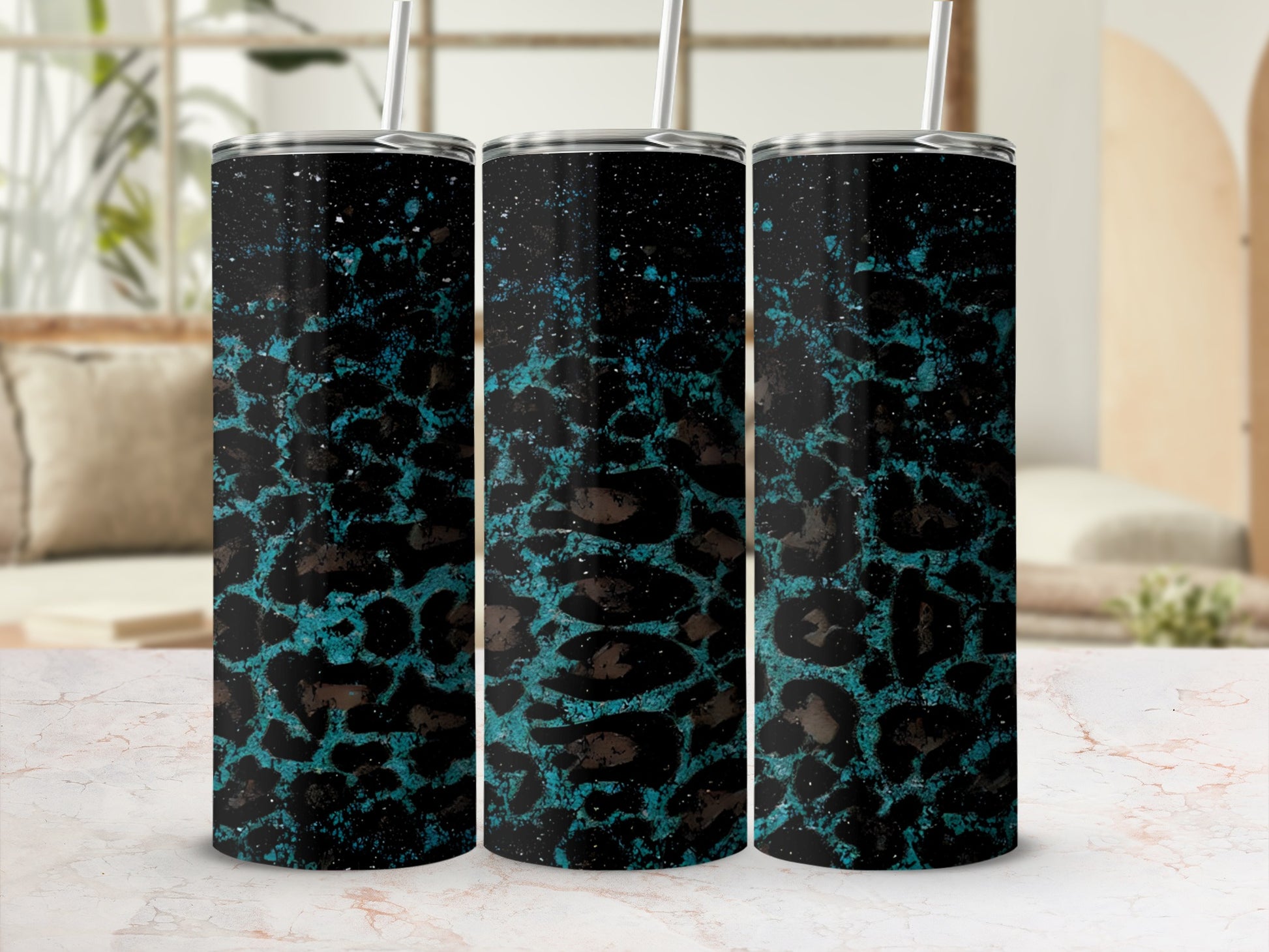 Black and teal leopard print tumbler with splatter details.