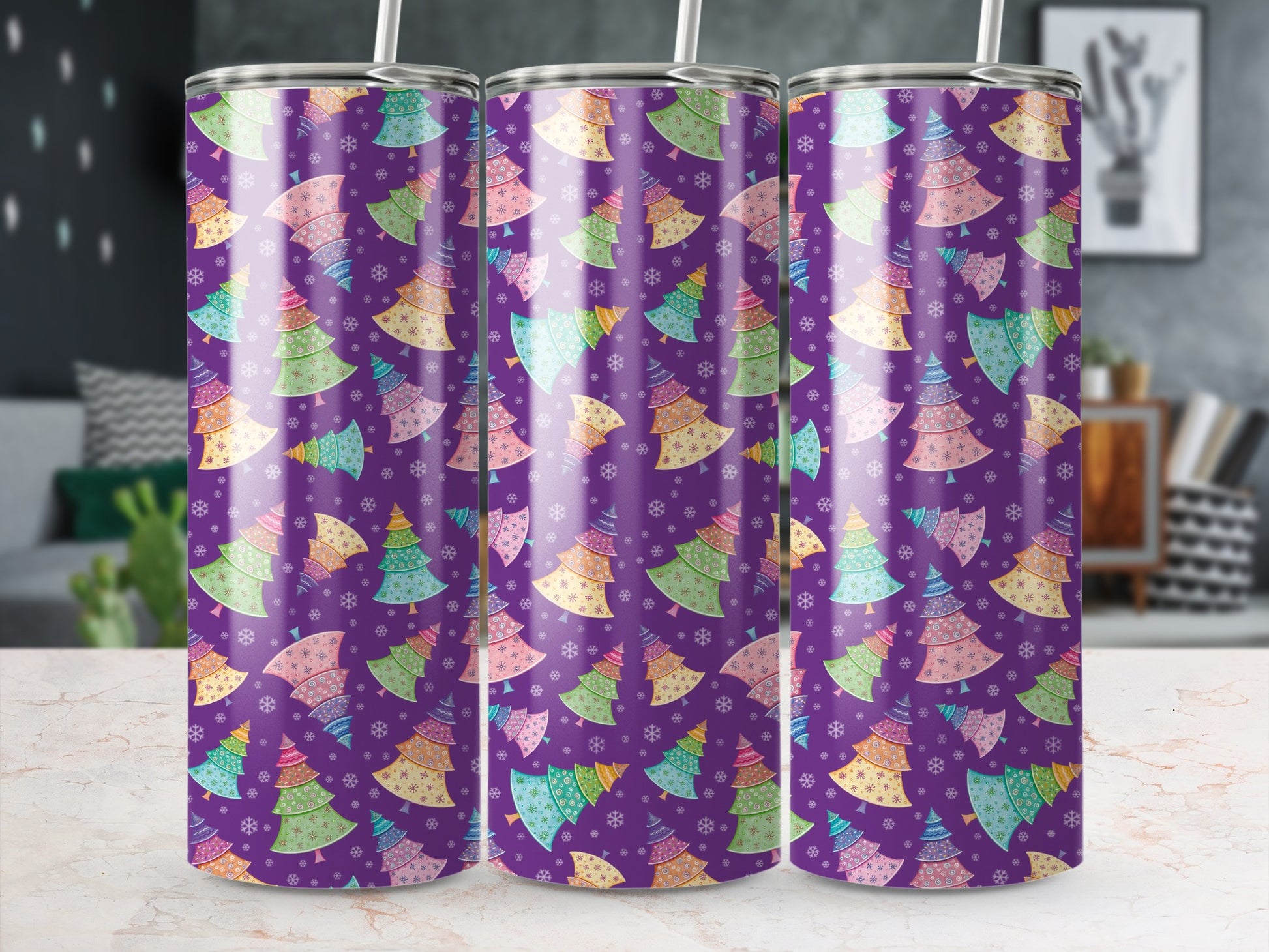 Purple tumbler with colorful Christmas tree pattern and snowflakes.