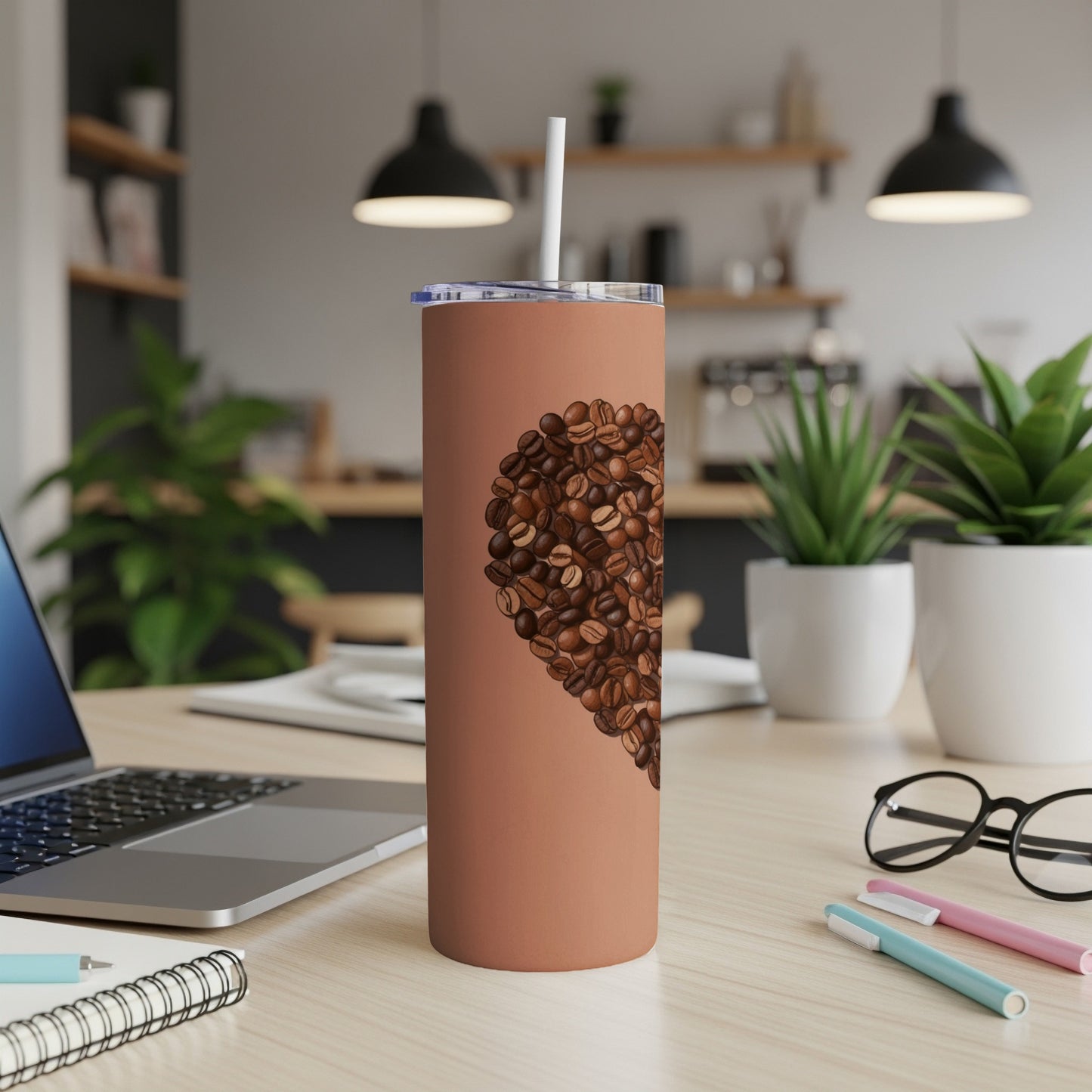 Brown tumbler with heart shape made of coffee beans.