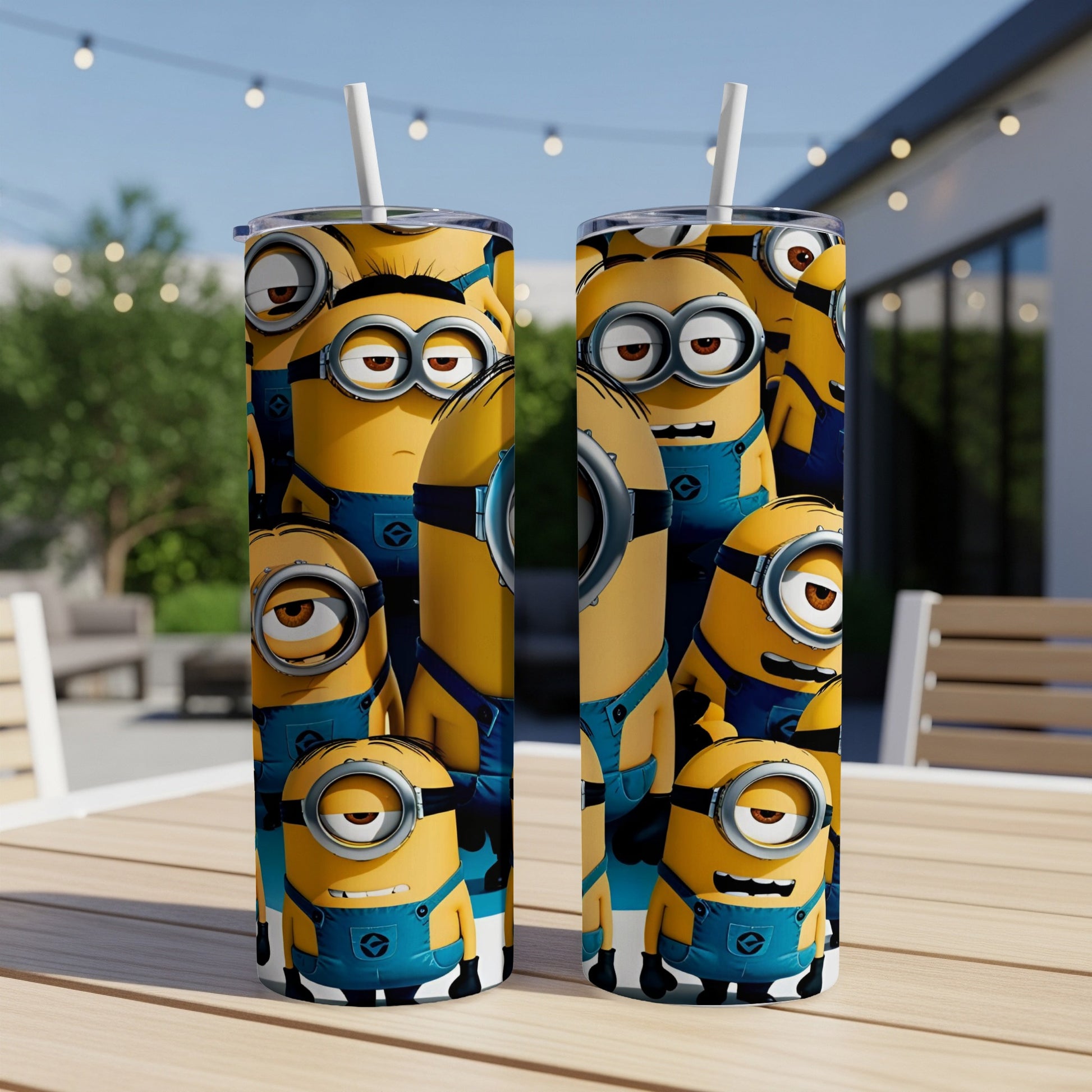 Two Minions-themed tumblers with straw on a table, outdoors.