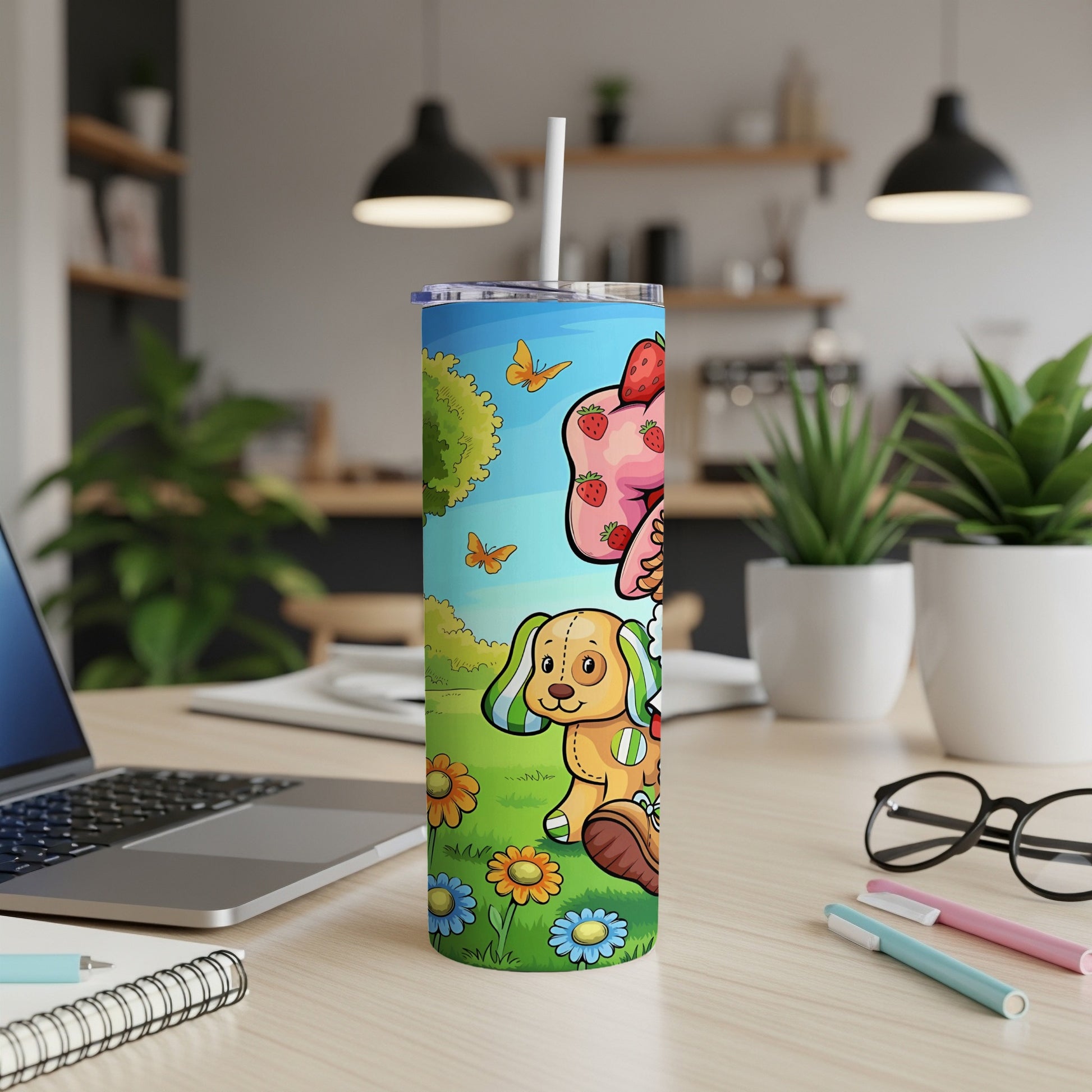 Cartoon dog with strawberries on a tumbler next to a laptop.
