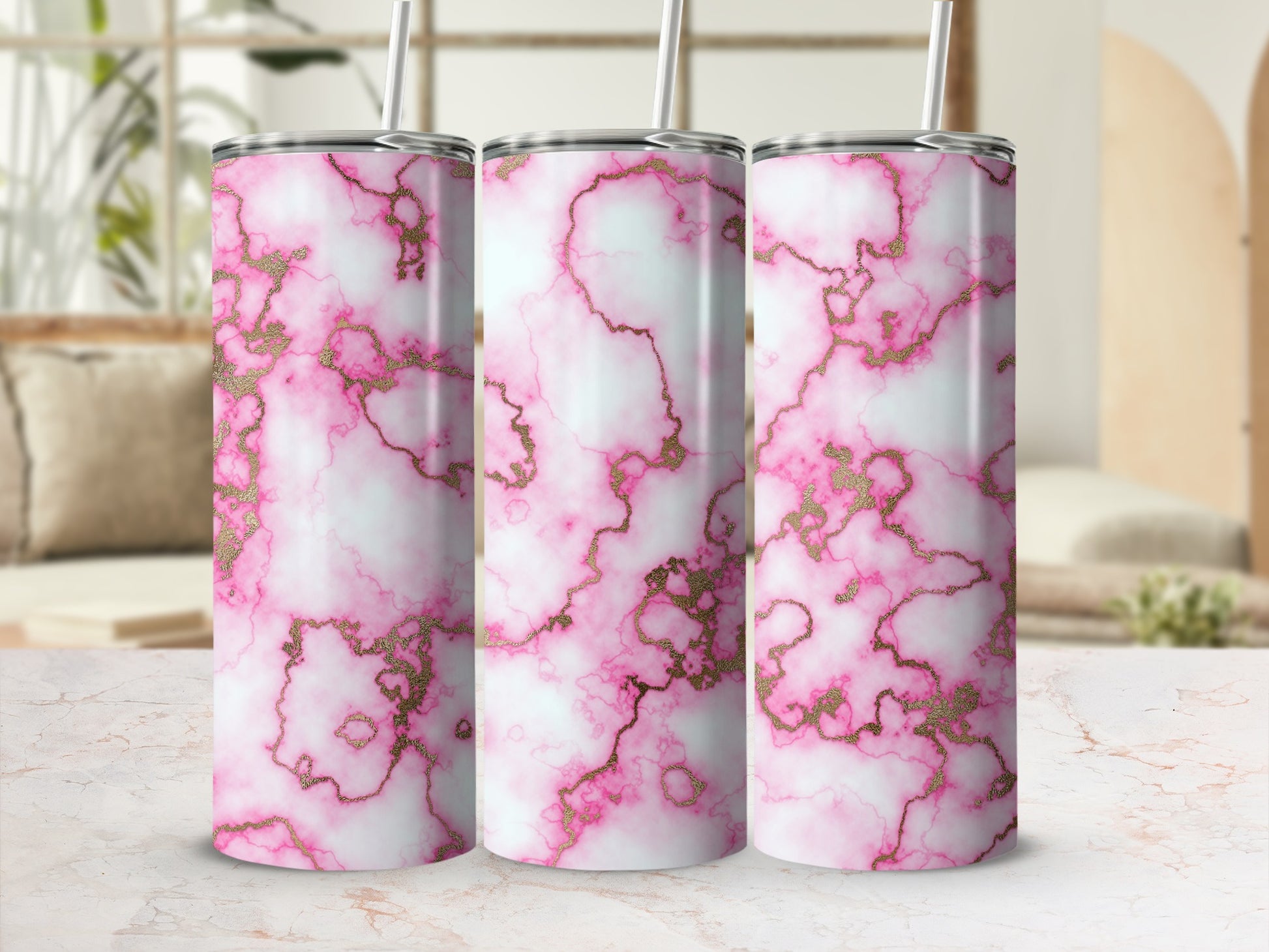 Pink marble tumbler with gold accents and straw on display.