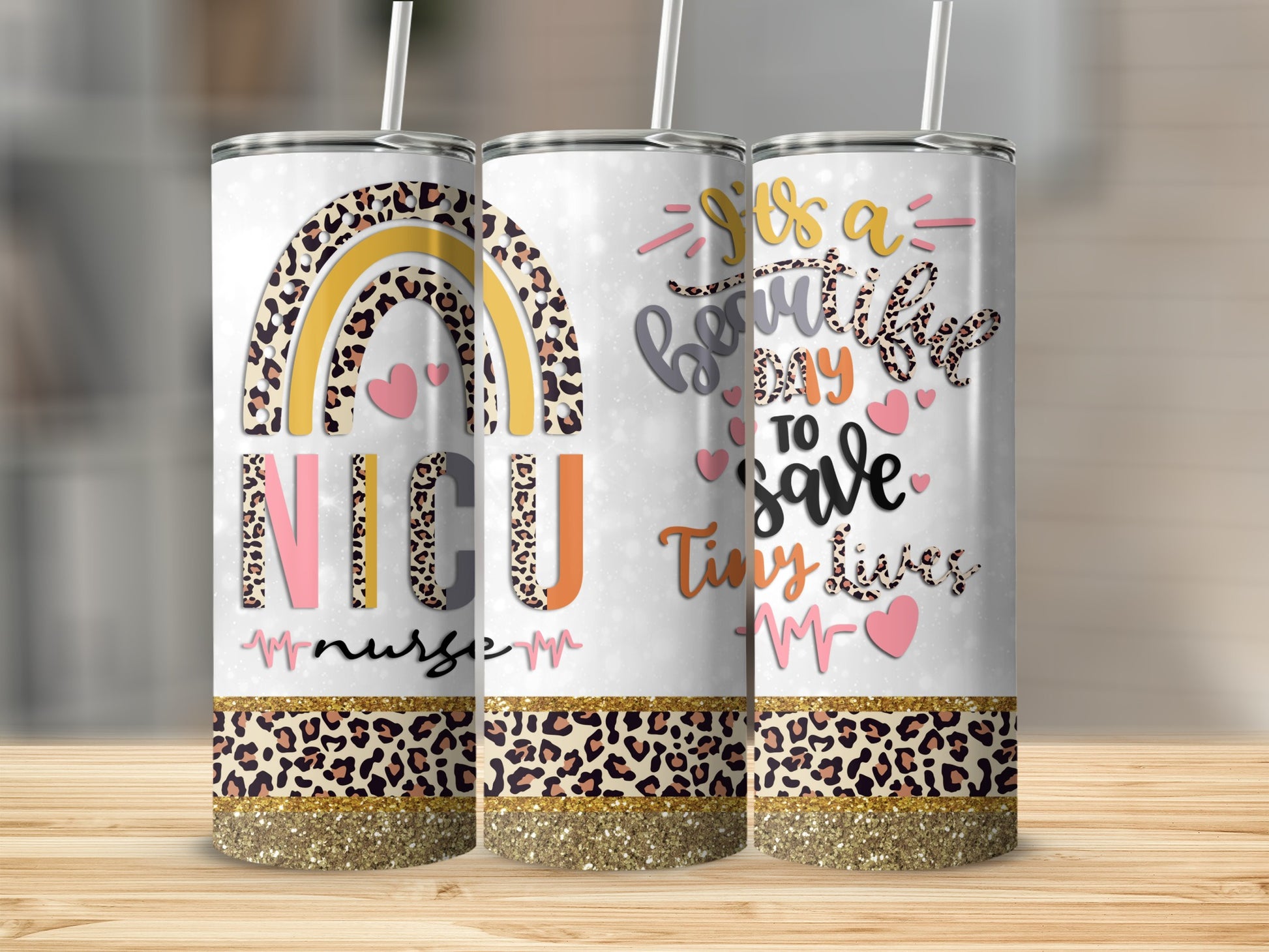 Three tumblers with rainbow and leopard print designs and inspirational text.