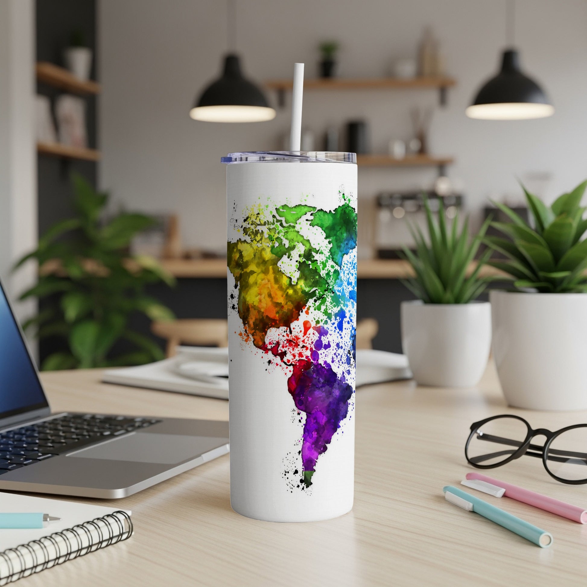 White tumbler with watercolor world map, featuring North and South America.