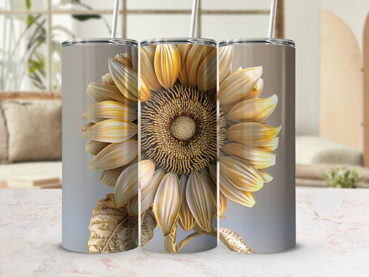 Sunflower tumbler with lid and straw, against a blurred background.
