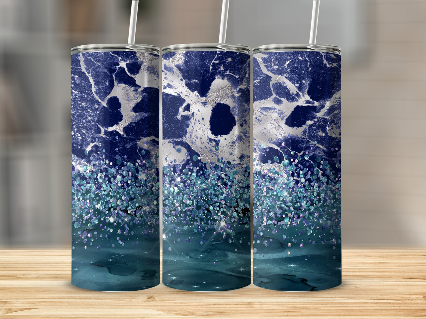 Three tumblers with blue and silver marble design and teal glitter accents.